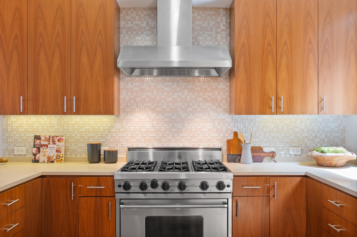 029photos403carl021762 Kitchen has stainless steel 6 gas burner Viking stove with stainless hood. Light multy cream colored tile backsplash throughout.