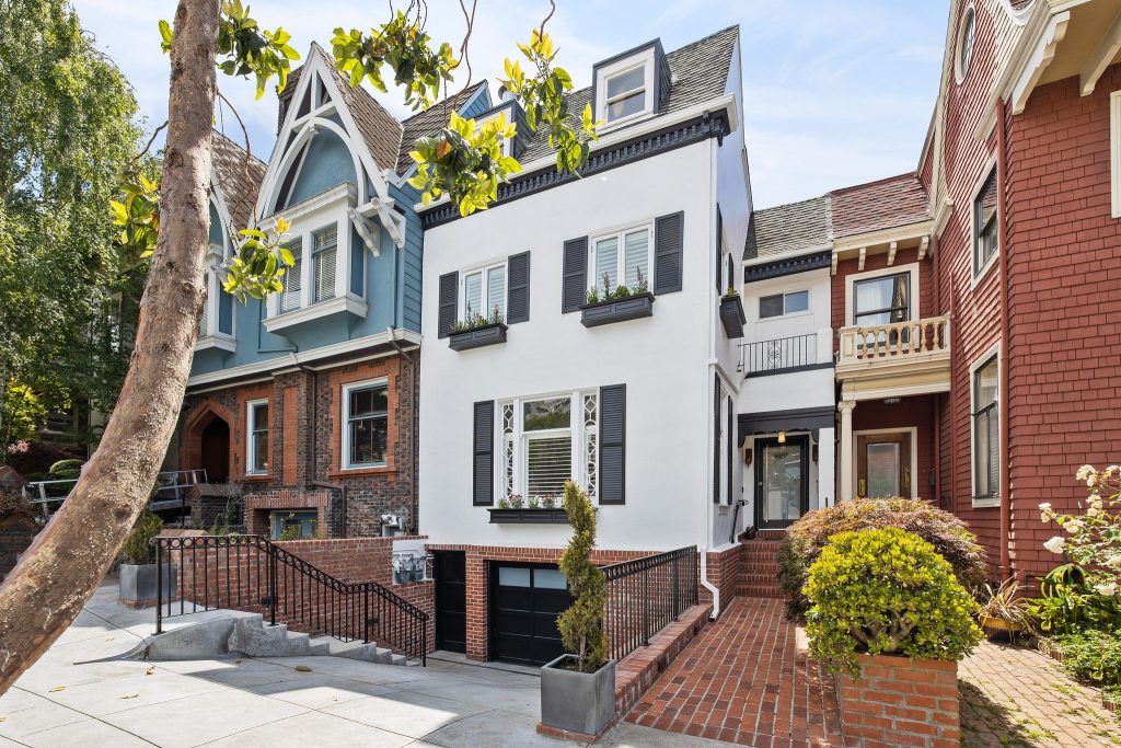 Front exterior view of 929 Ashbury Street, featuring a cheery white facade