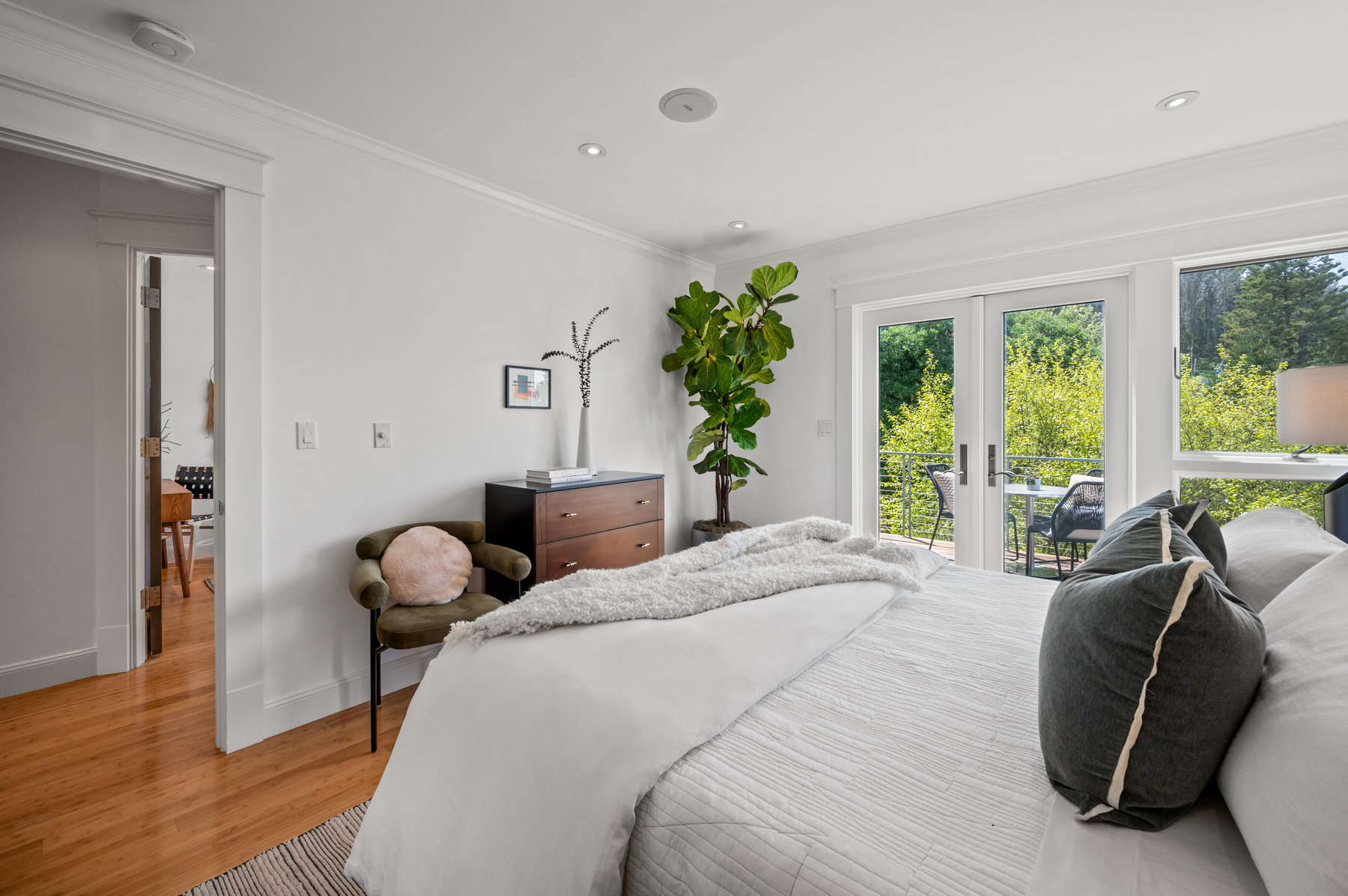 Primary bedroom has a king size bed, dresser and chair.  There are hardwood floors throughout.