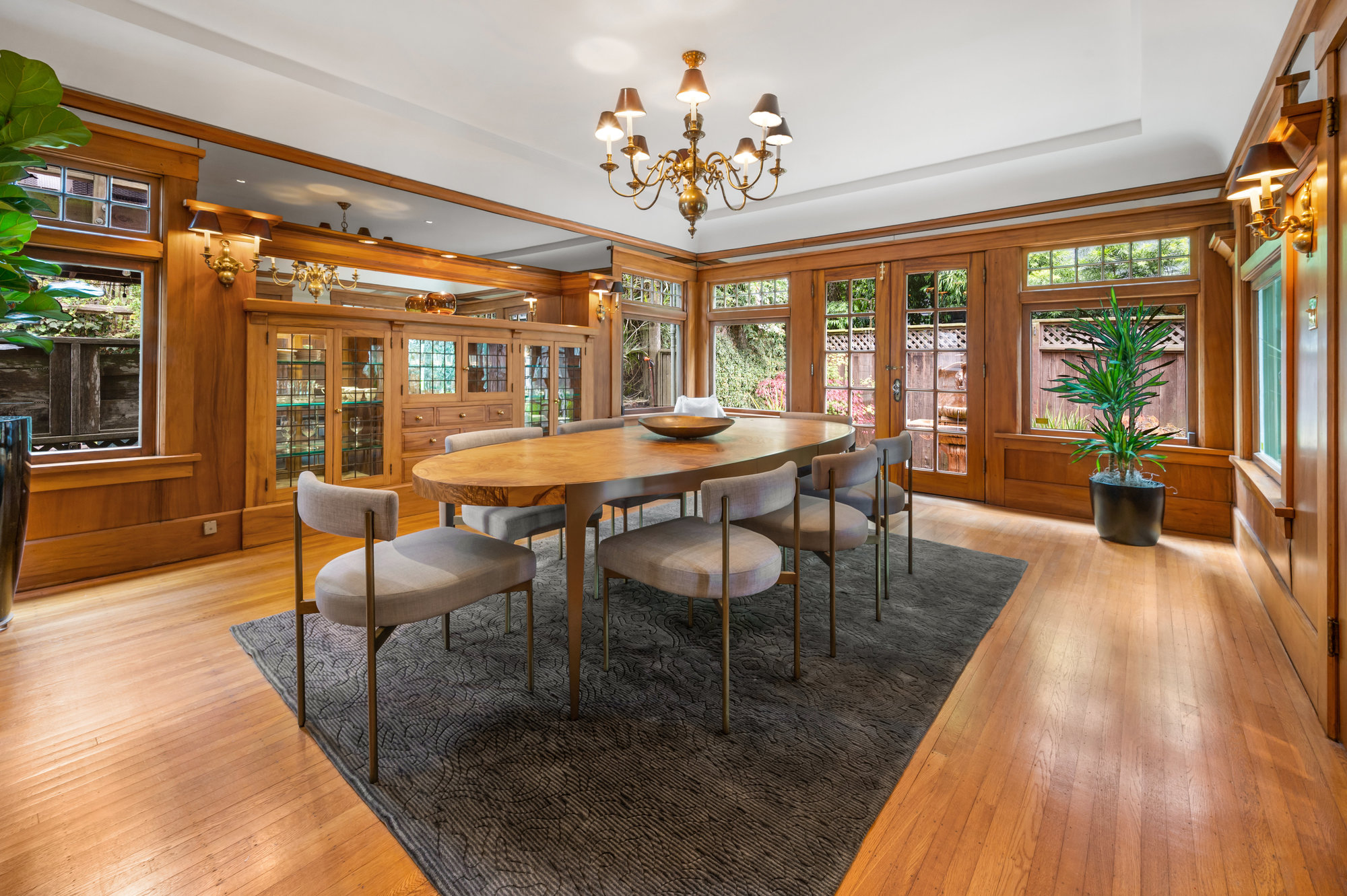 Dining room with built-in wood shelves and exterior French glass doors