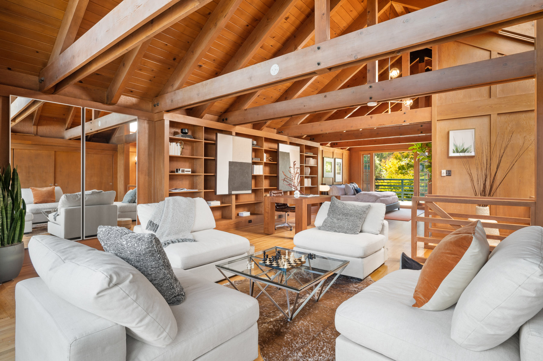 Looking over sitting area in upper level.  Features stunning wood detailing, large beamed ceilings.