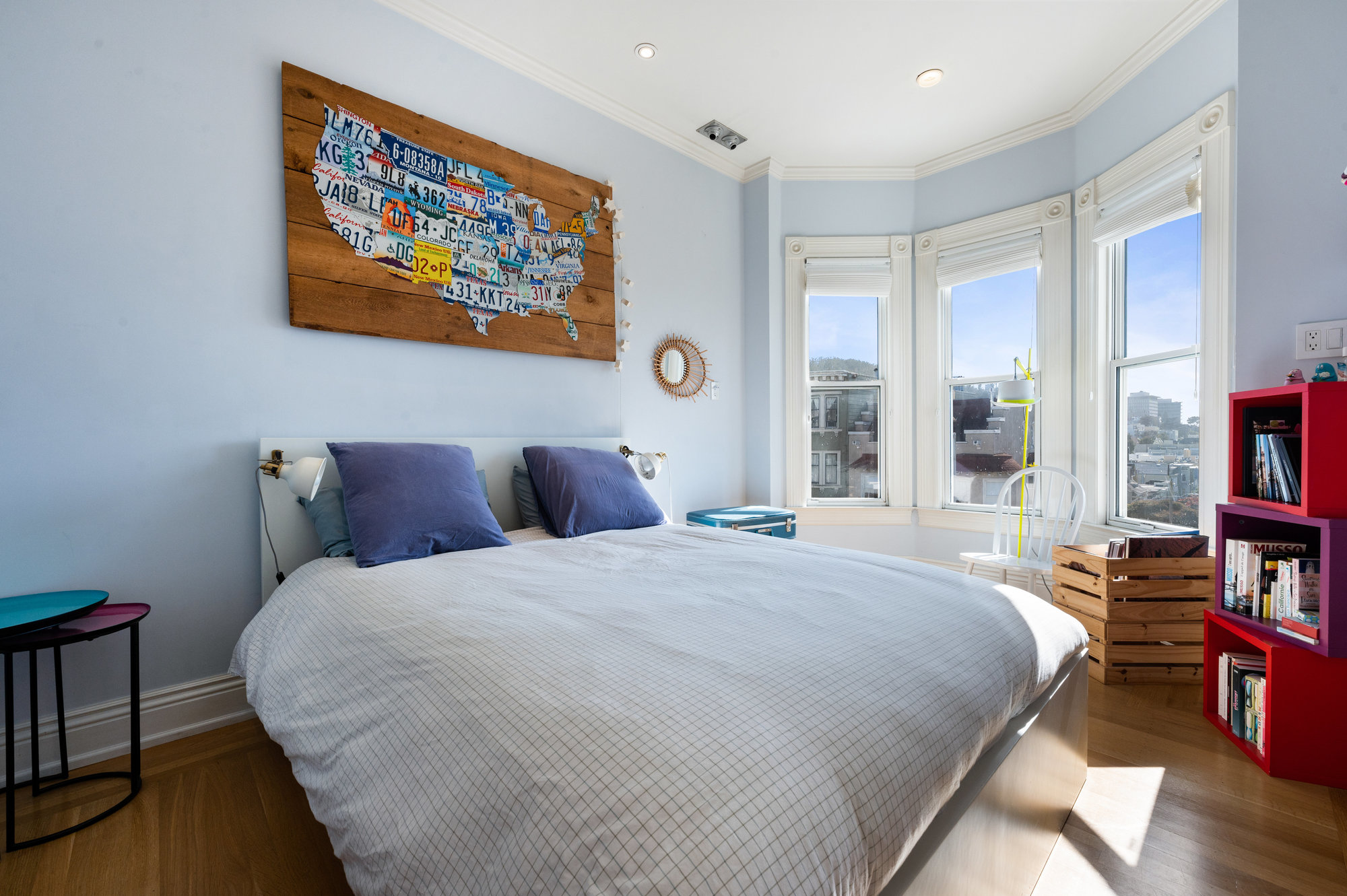 View of a second bedroom with large bay windows with wide woodwork
