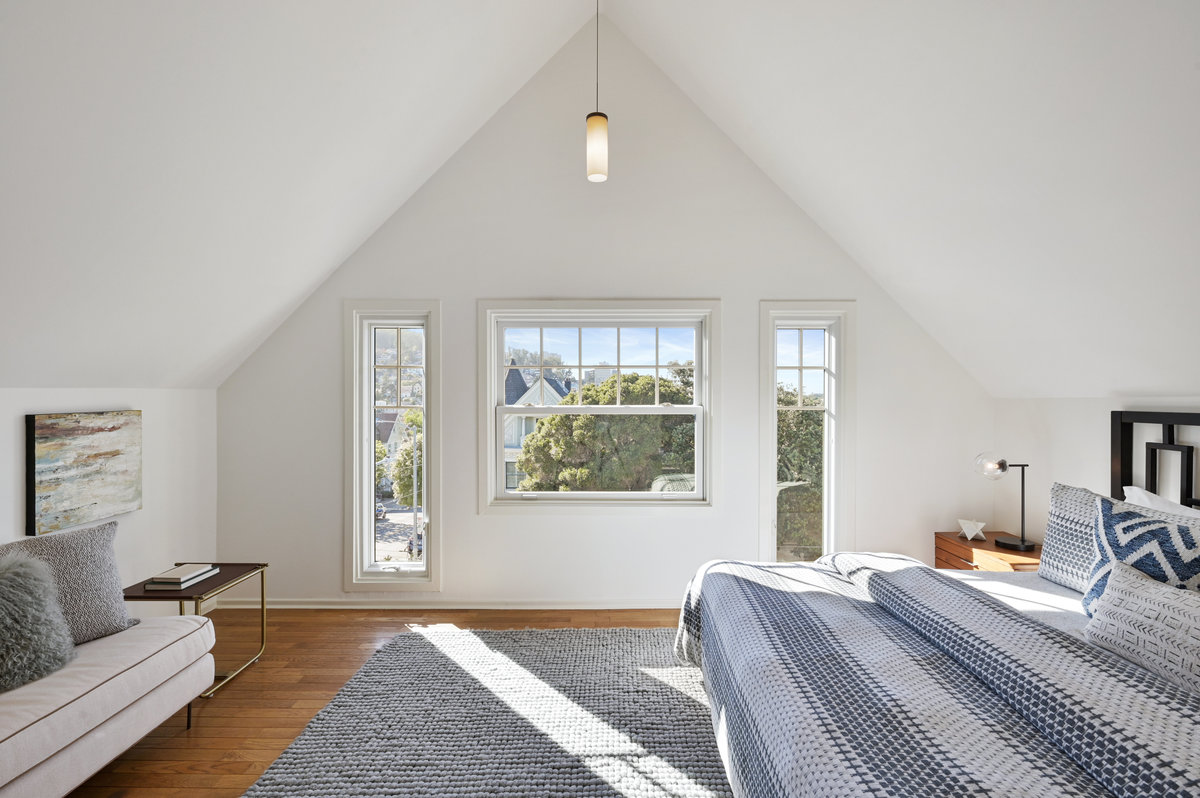034057 Primary bedroom with slanted ceilings and large windows