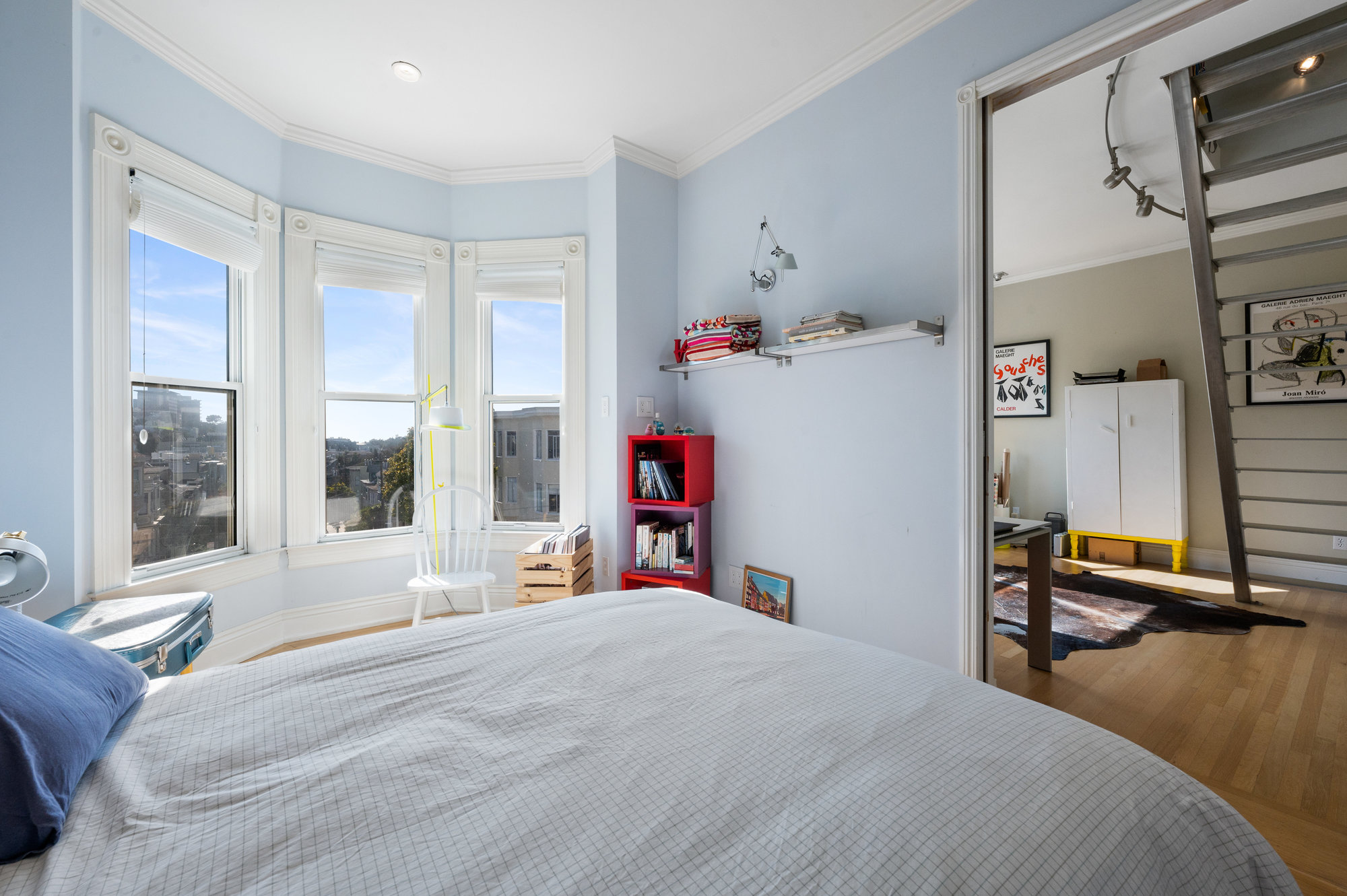 View of the second bedroom looking into an office area, wood floors can be seen throughout
