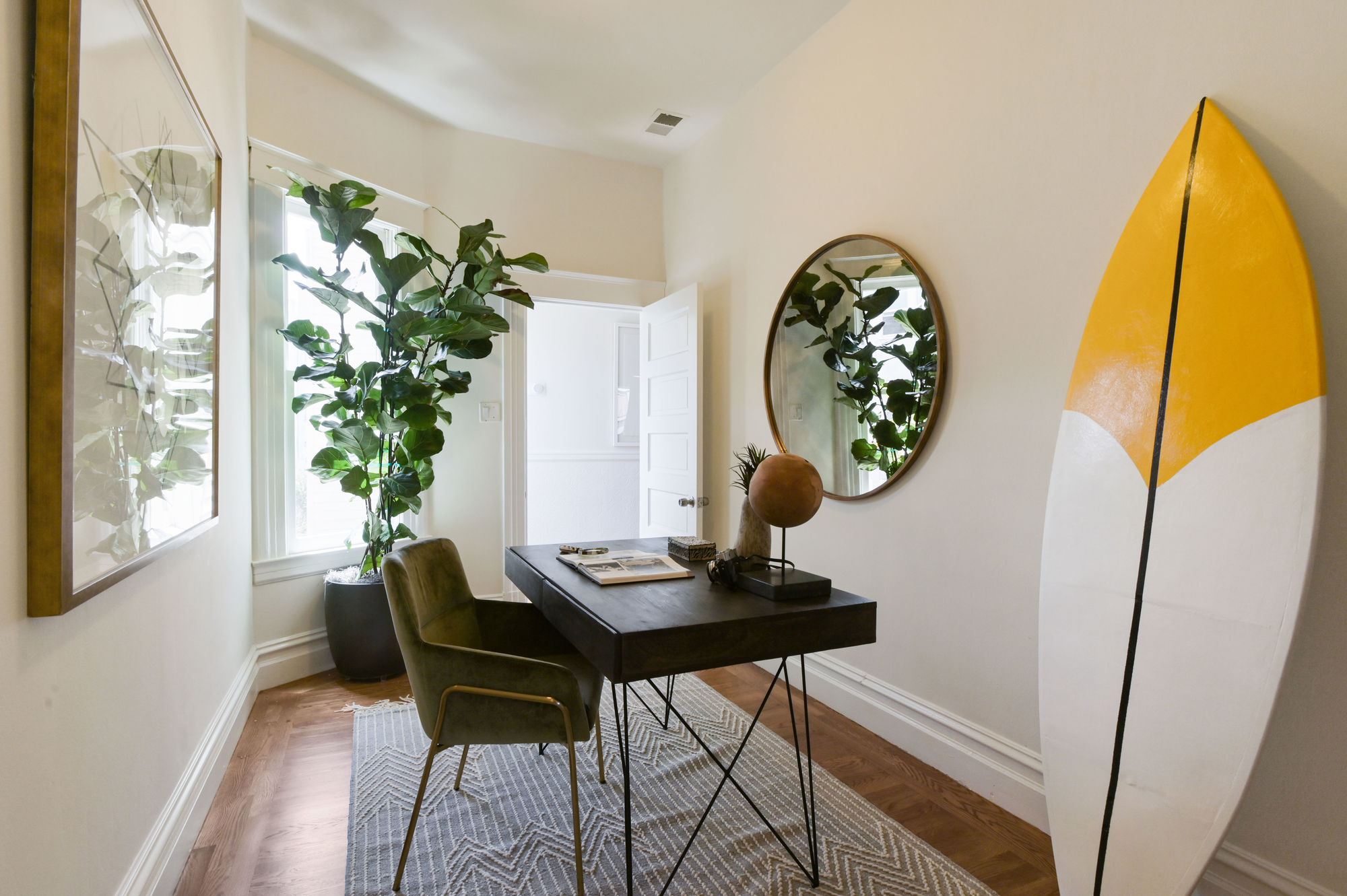 View of a cozy office area with wood floors and natural light