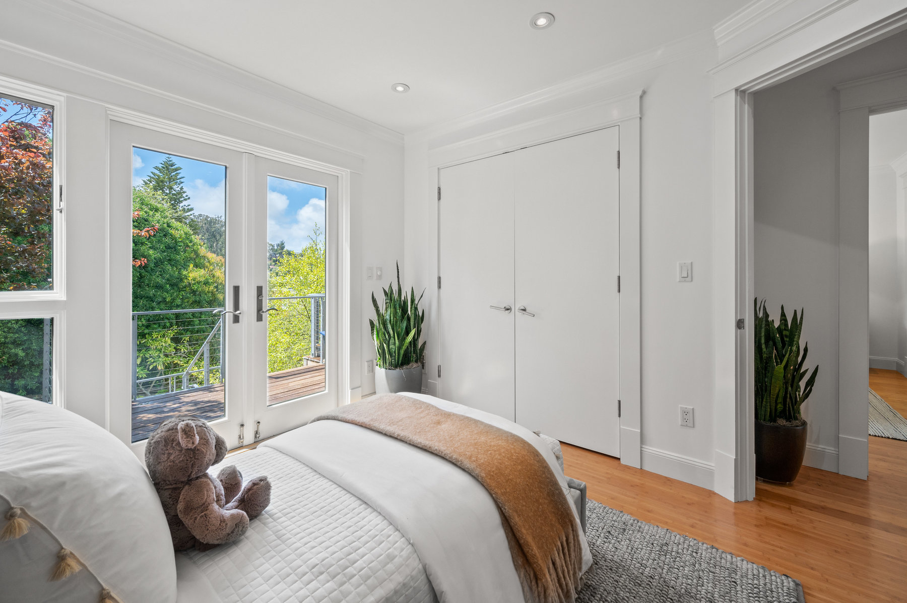 The second bedroom also has hardwood floors and looks out to deck with beautiful greenery in the back yard.