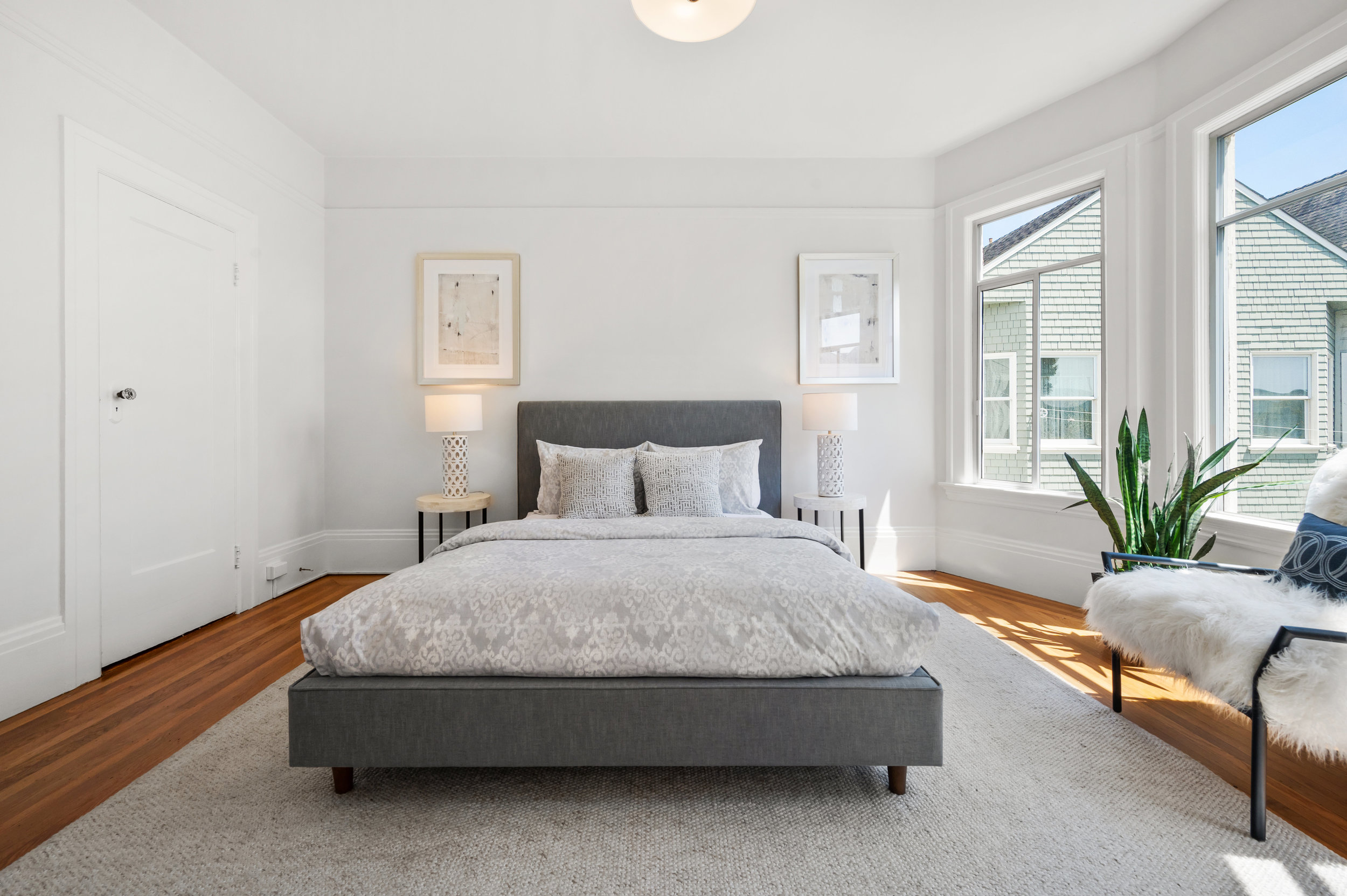 View of the second bedroom showing a large closet and wood floors