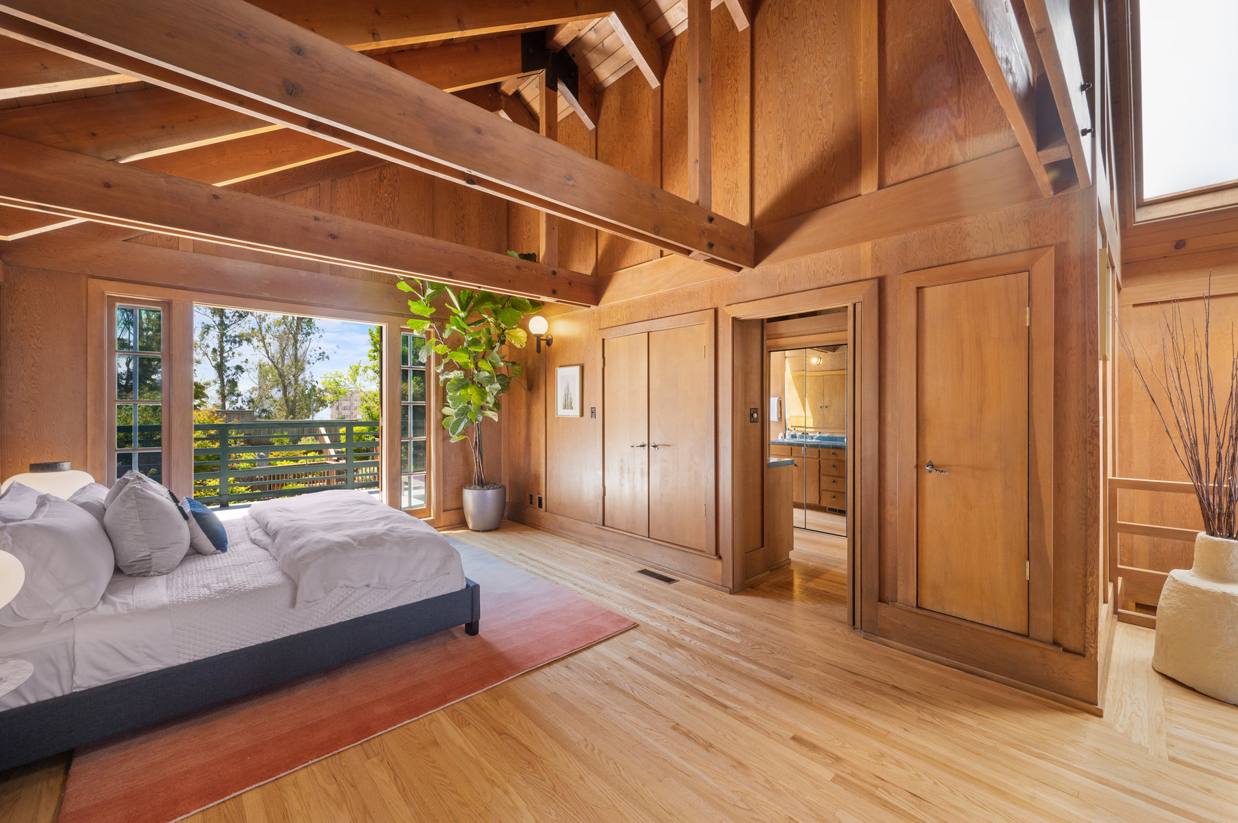 Photo highlighting bedroom area.  There are large built in closets along the right-side wall. Door leads to bathroom.
