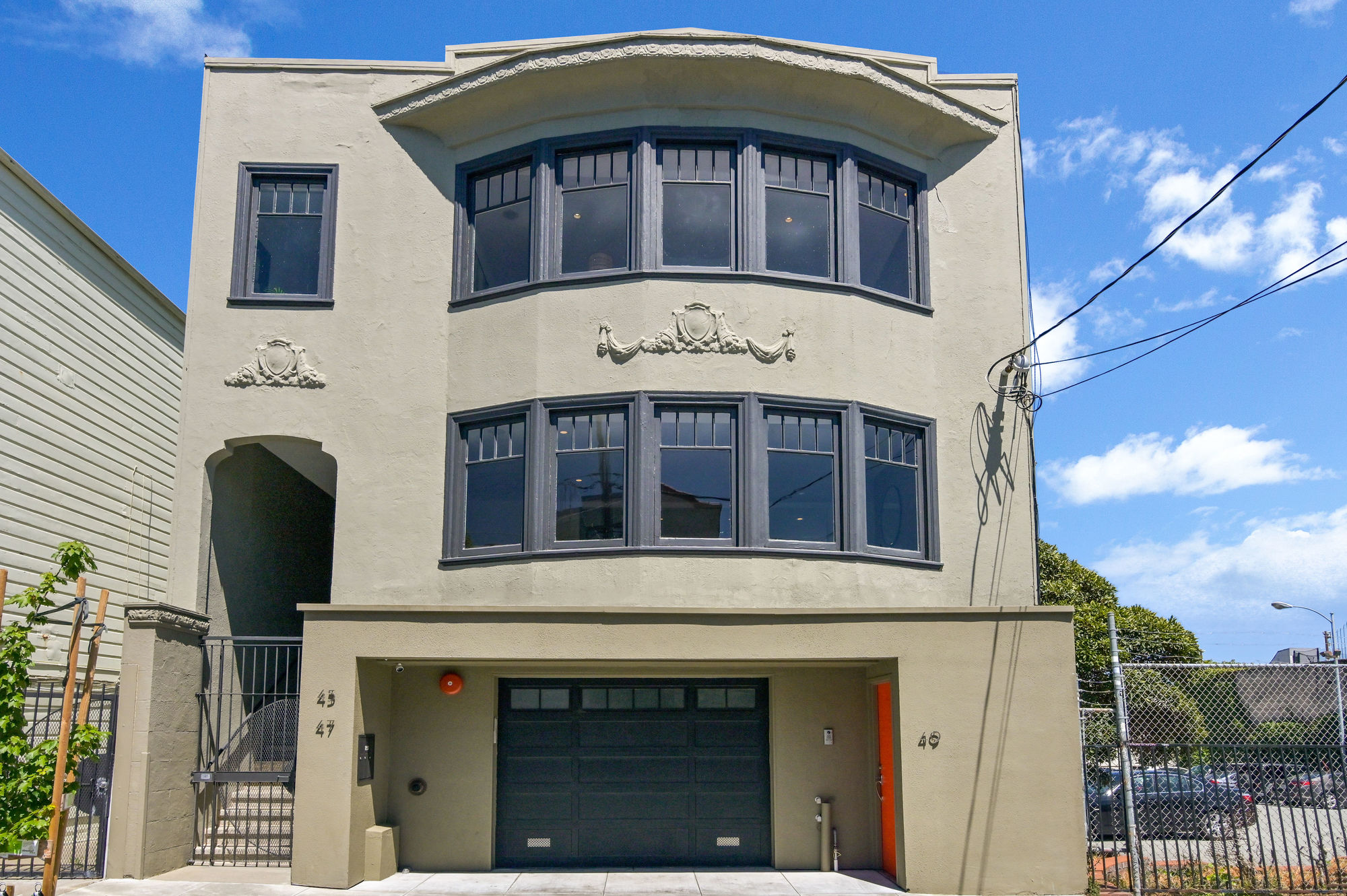 0421 Front exterior view of 45-49 Belcher Street, featuring a tan facade