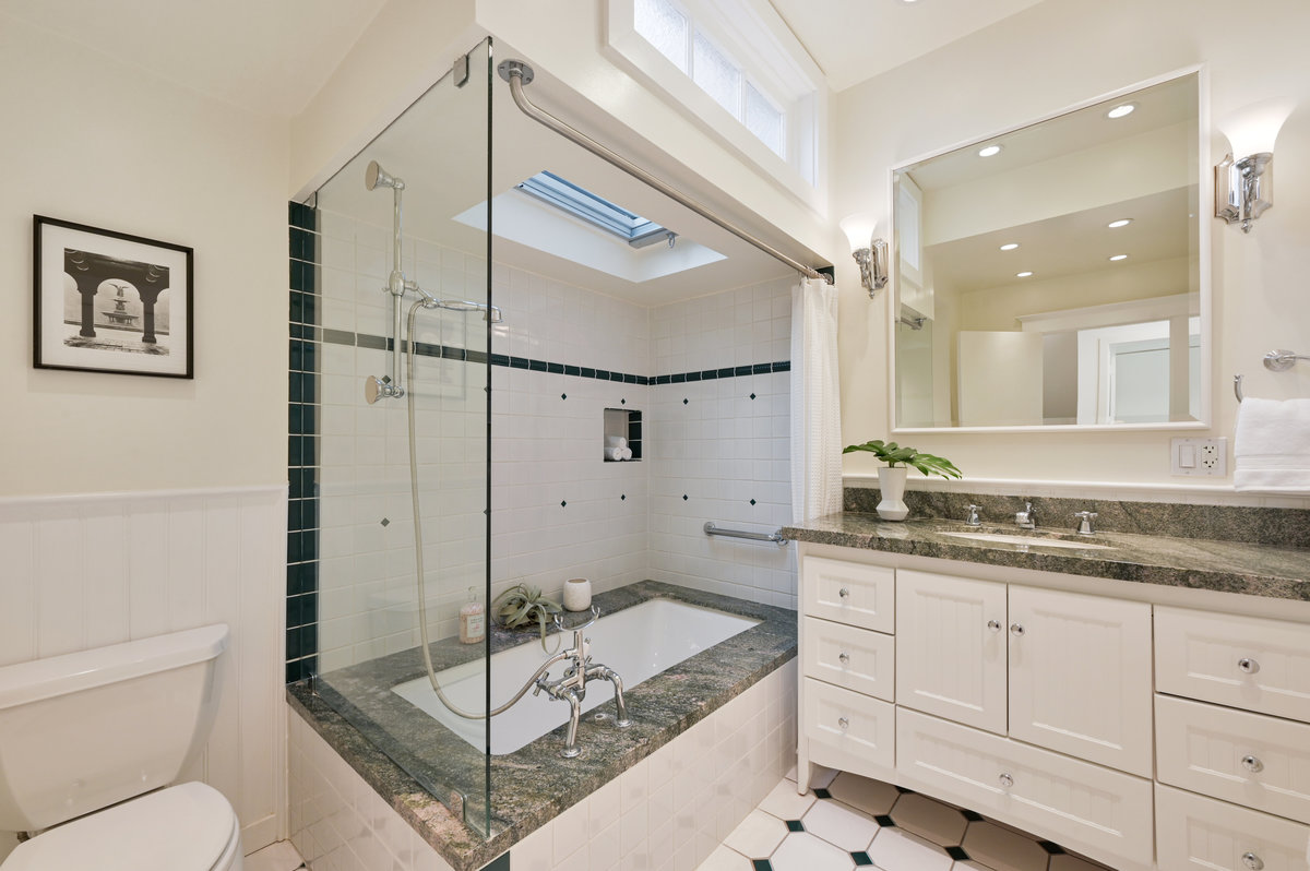 045079 Bathroom two, showing a large vanity, shower and bath with a skylight above