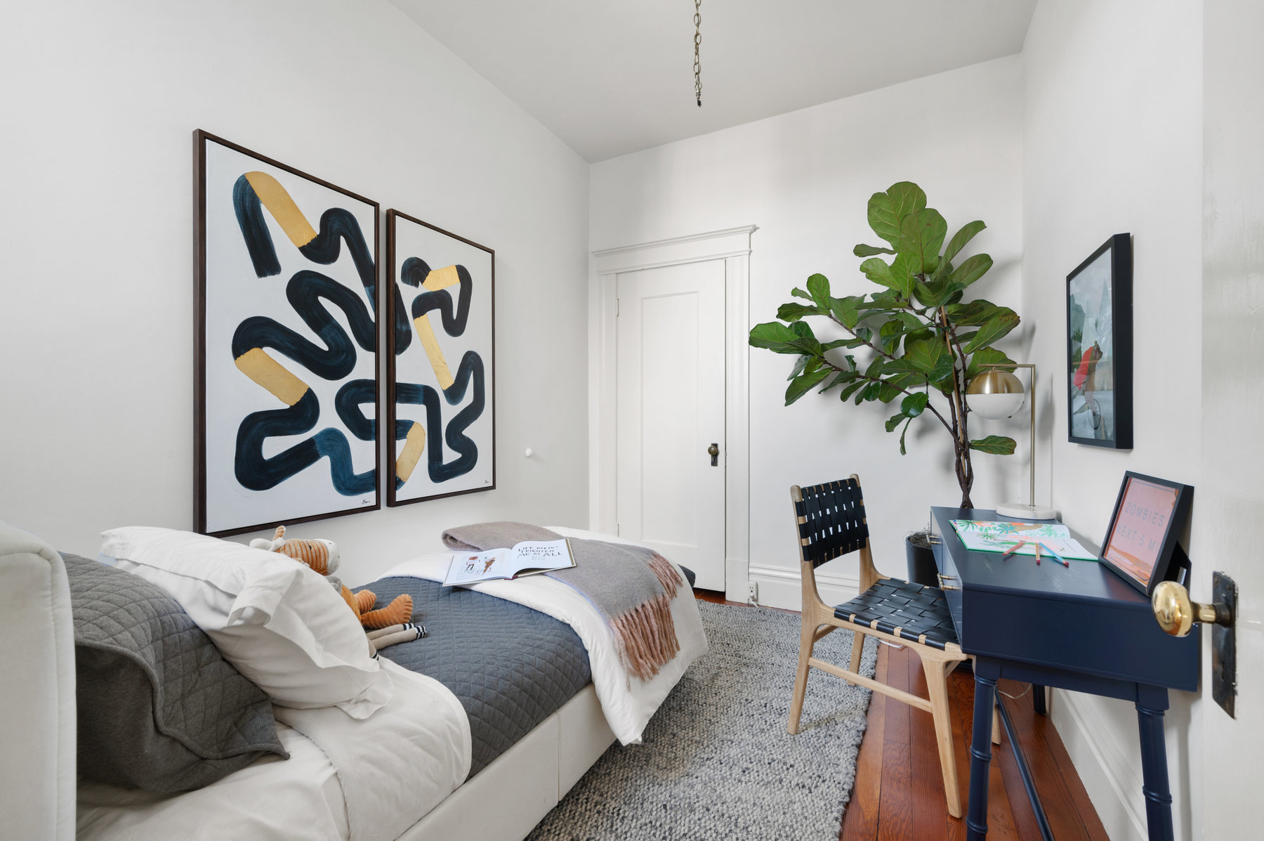 Guest room with single bed and small desk.