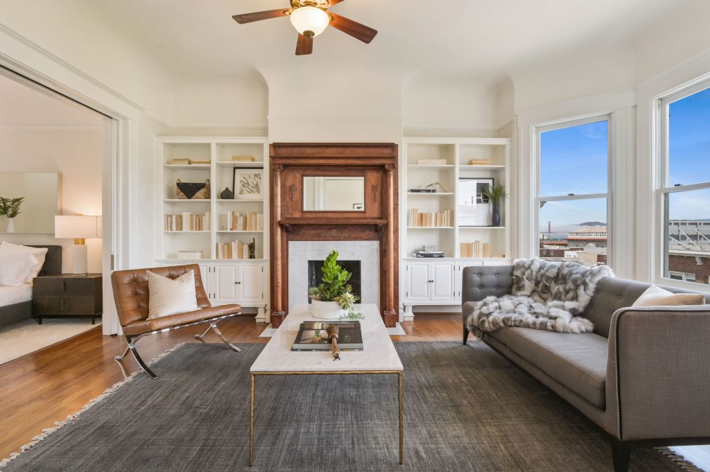 View of the living room at 1527 Pacific Avenue, showing a fireplace with beautiful wood mantle and built-in shelves
