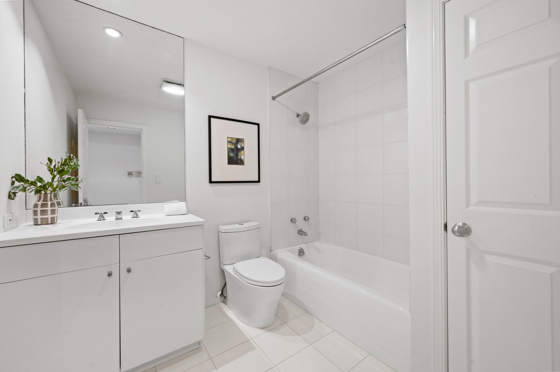 Guest bathroom has tub shower combo.