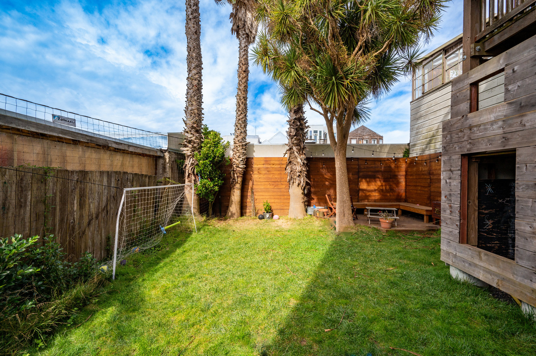 Photo of shared backyard highlighting the green grass yard.