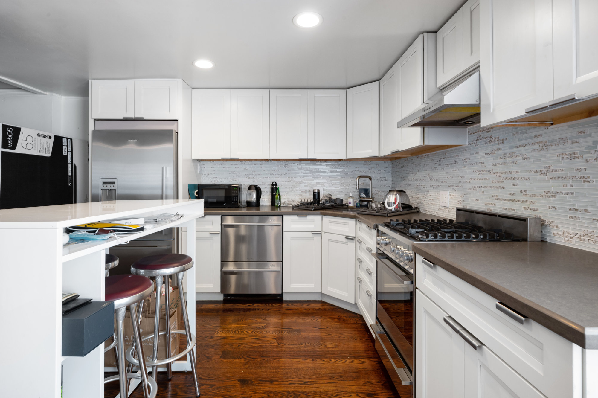 Primary cooking area, featuring white cabinets and stainless steel appliances