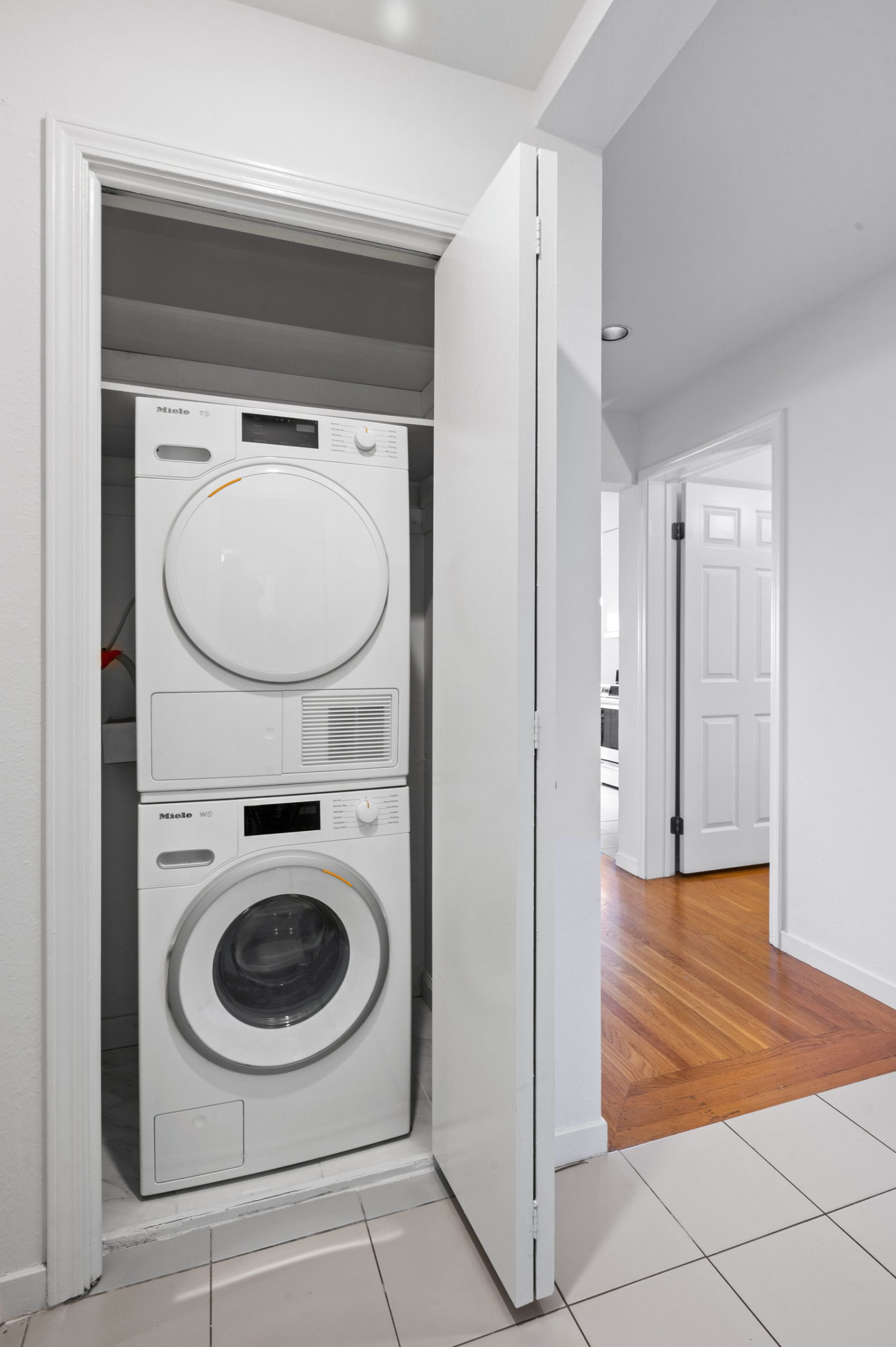 Washer and dryer in closet next to guest bathroom