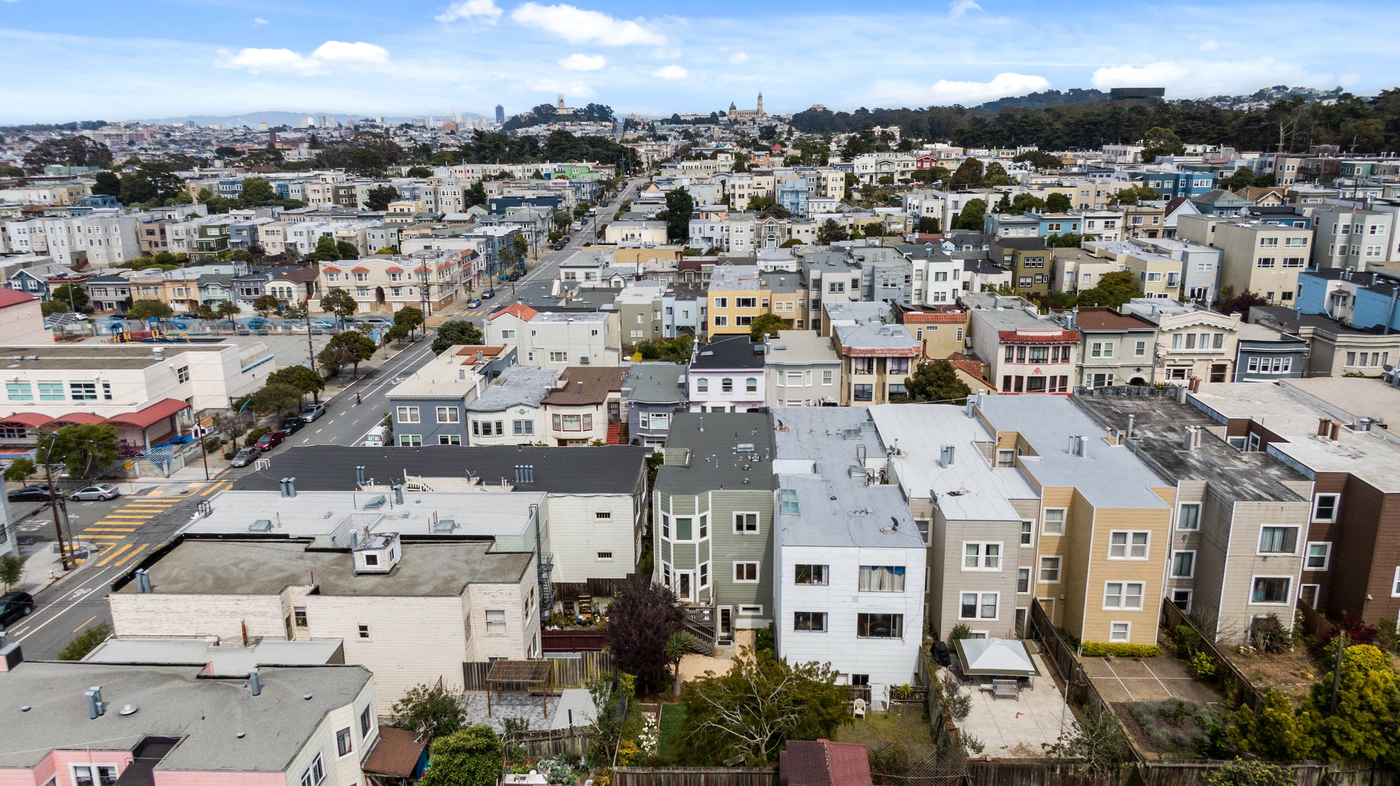 Aerial of 719 18th Avenue, showing the rear exterior of the home and the surrounding community