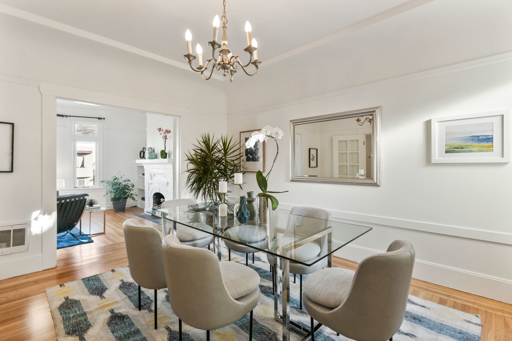 Formal dining area with wood floors and white walls