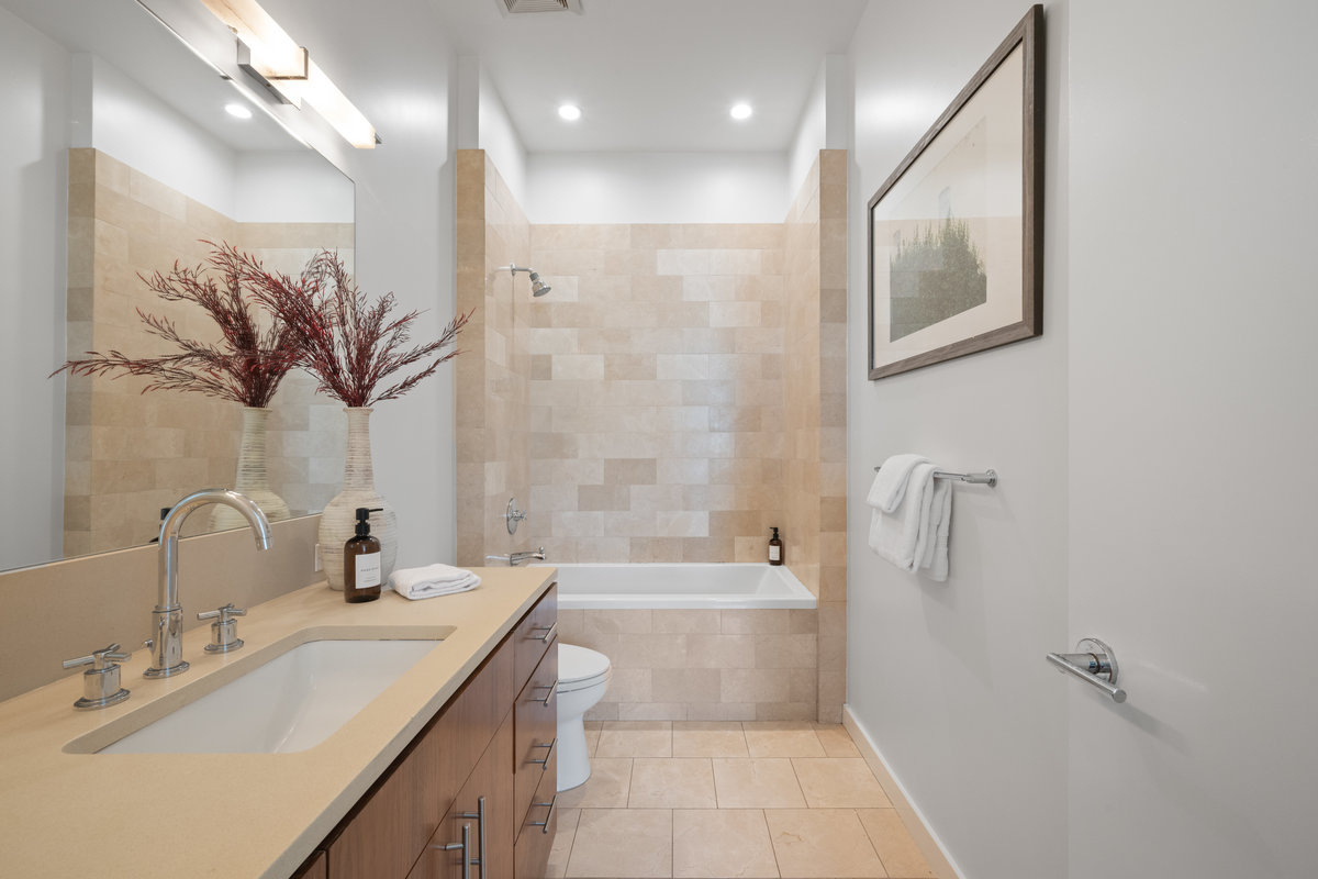 068photos403carl060789 On suite guest bathroom has large vanity and a shower/tub combo.