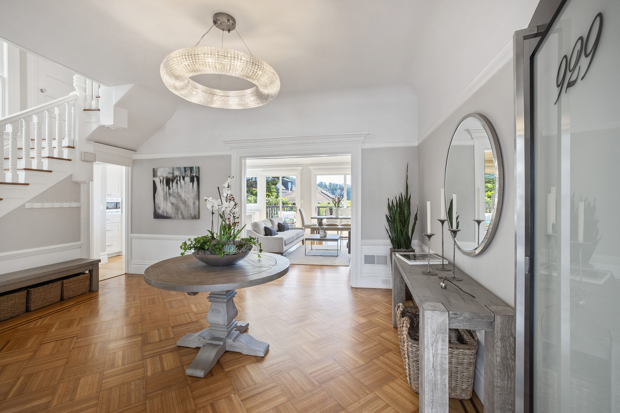View of the large formal entry space, featuring wood floors