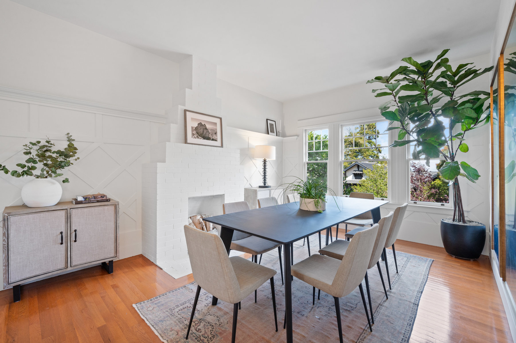 Looking into dining room from entry.  There is a large rectangular table that seats 10.