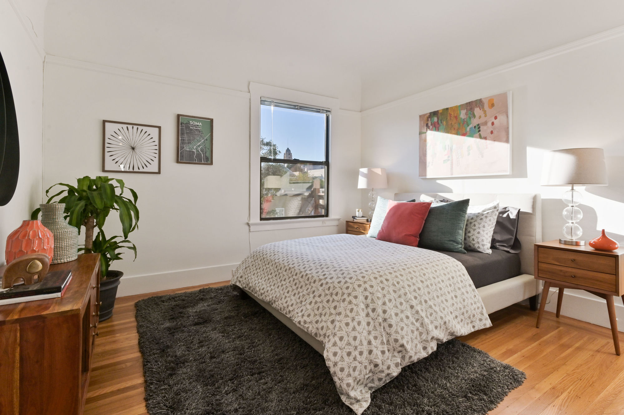 Bedroom with wood floors and a large window