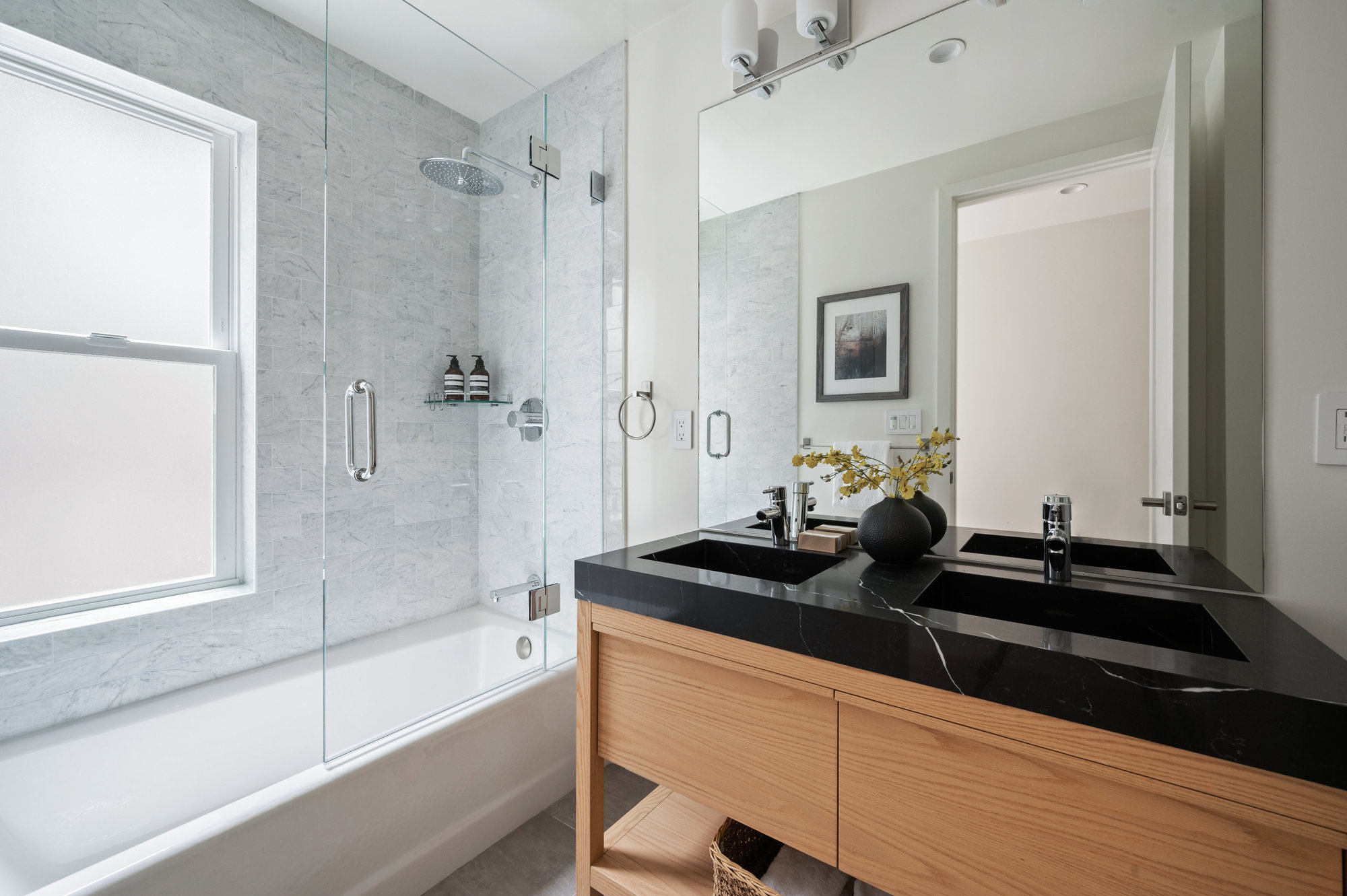 Guest bathroom has tub/shower combo and double vanity.