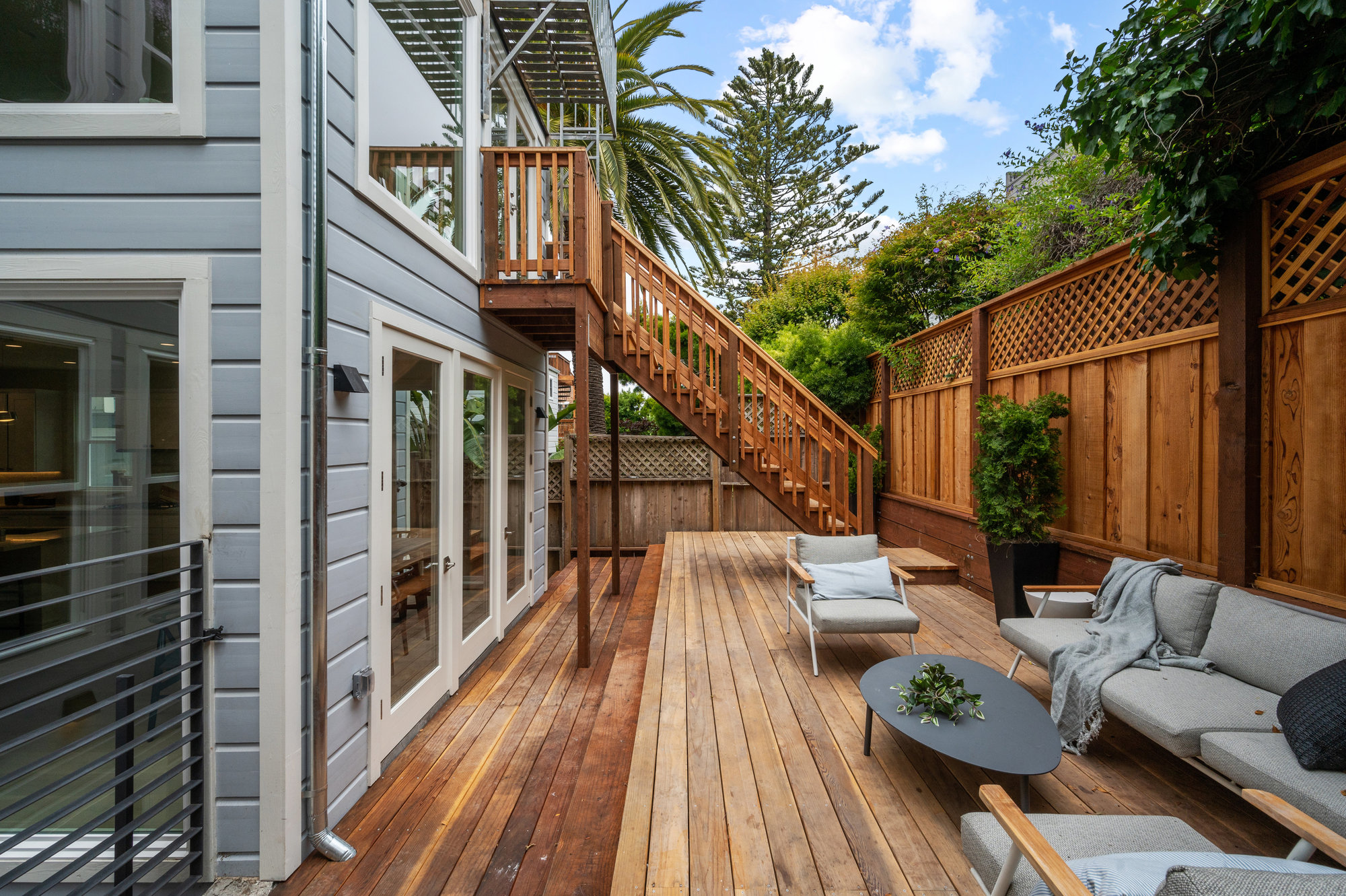 Photo showing length of deck.  There is a stairway that is a fire escape for upper level.