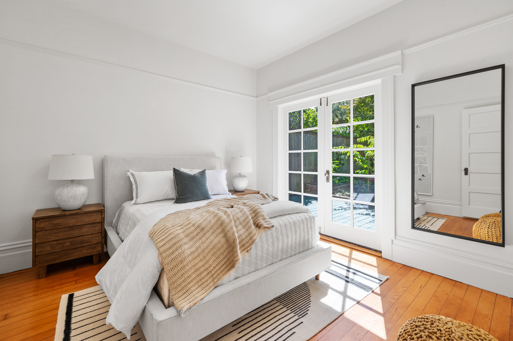 Guest bedroom in the backside of home. Has french doors that open up to back yard.