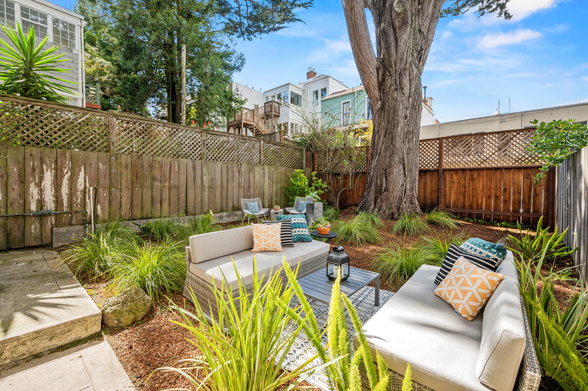 087photos41delmarpu009 Looking at yard from entry of bonus space. There is a nice sitting area and is well manicured with greenery and wood chips. C