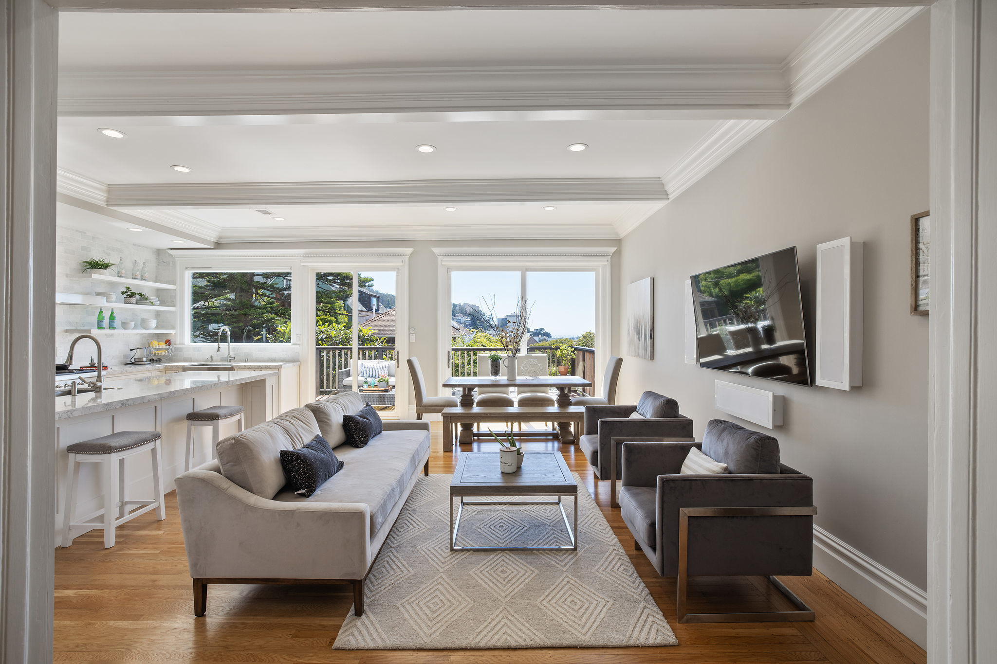 View of the living area, featuring white wood beamed ceilings and wood floors