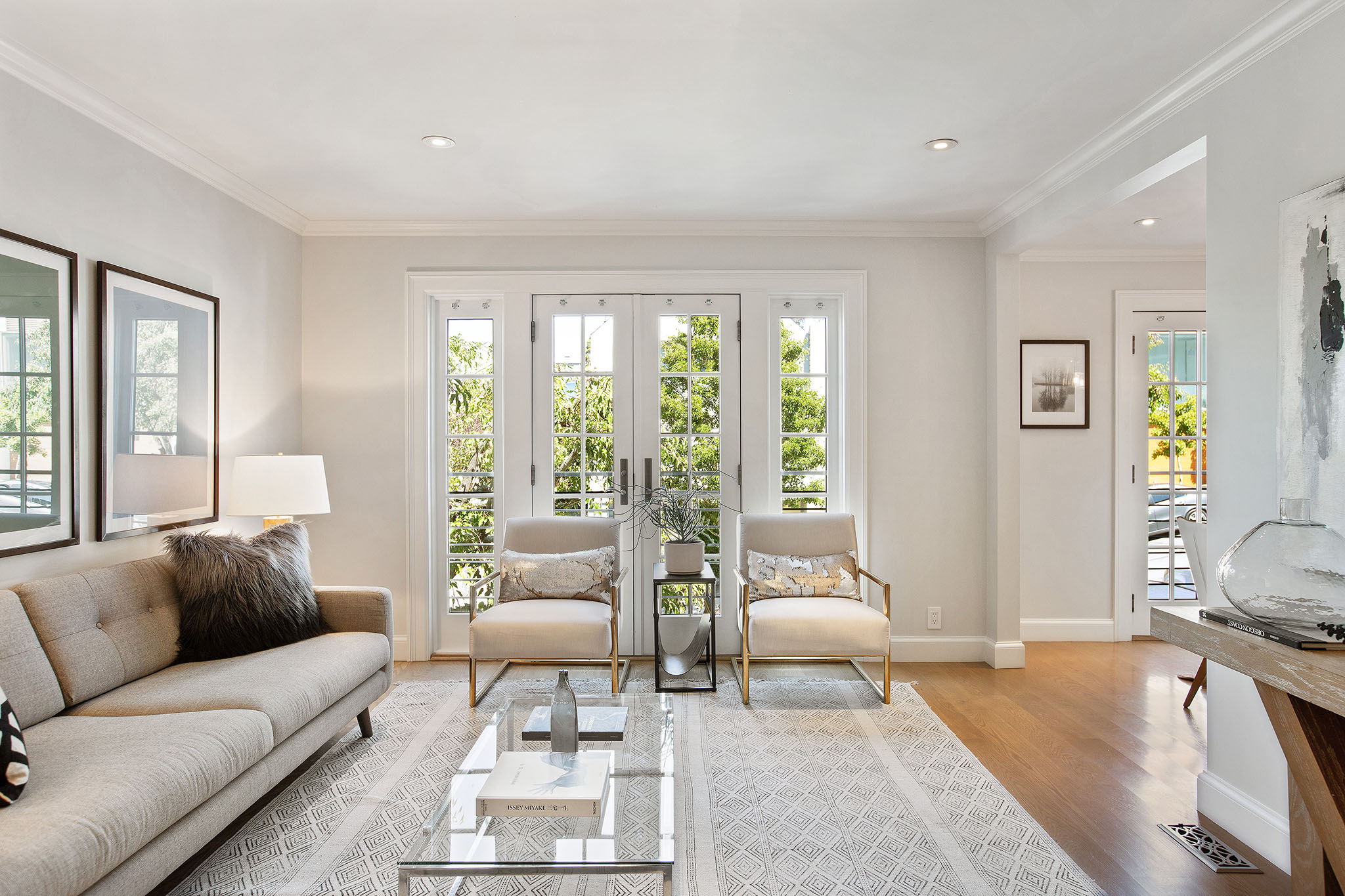 Photo with french doors centered. There are two chairs in front of doors.