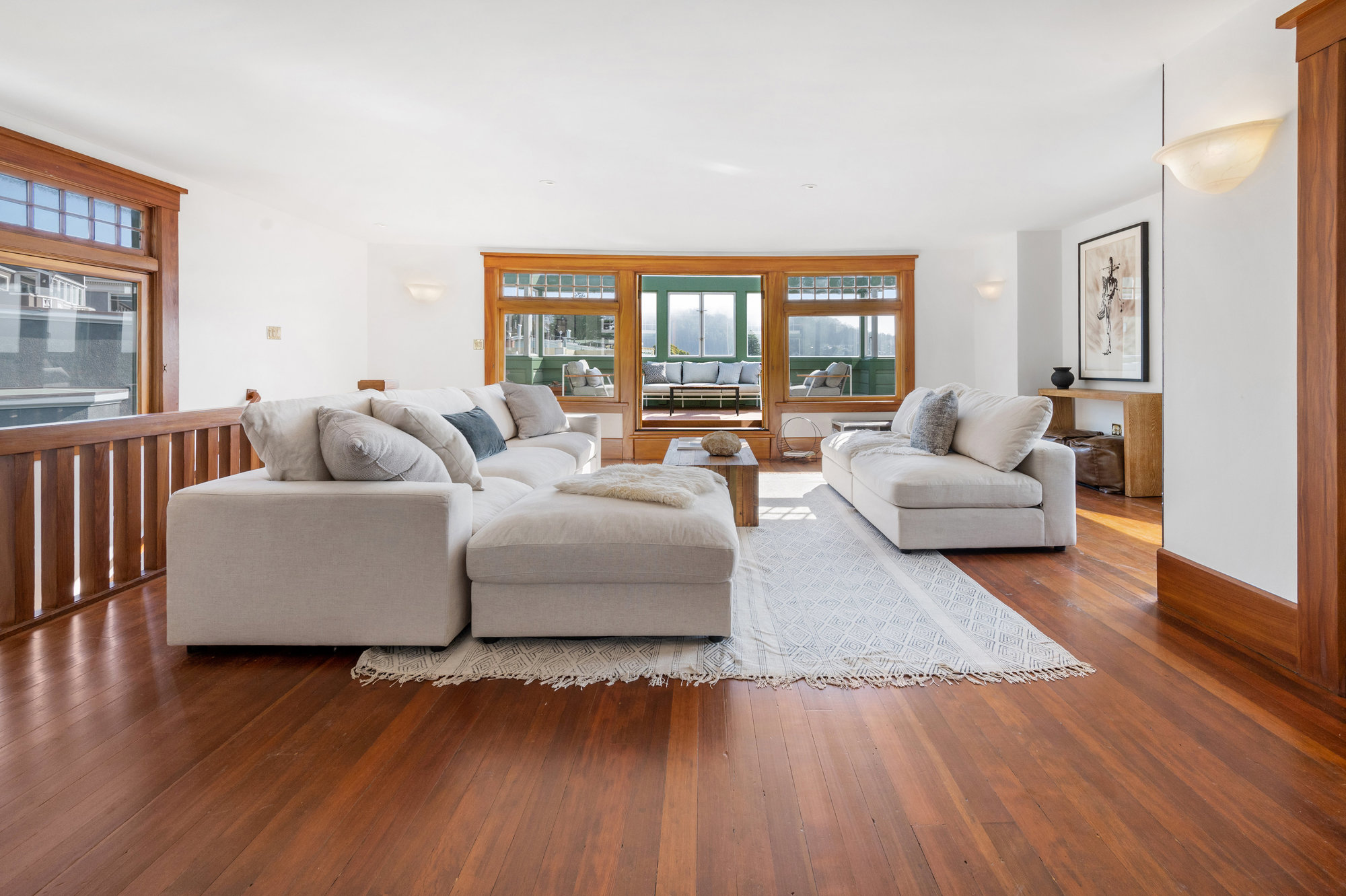 View of the large upper living area with wood floors at 4 Ashbury Terrace in San Francisco