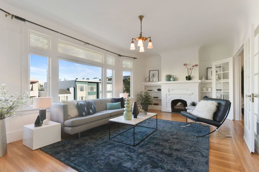View of living room with wood floors and fireplace