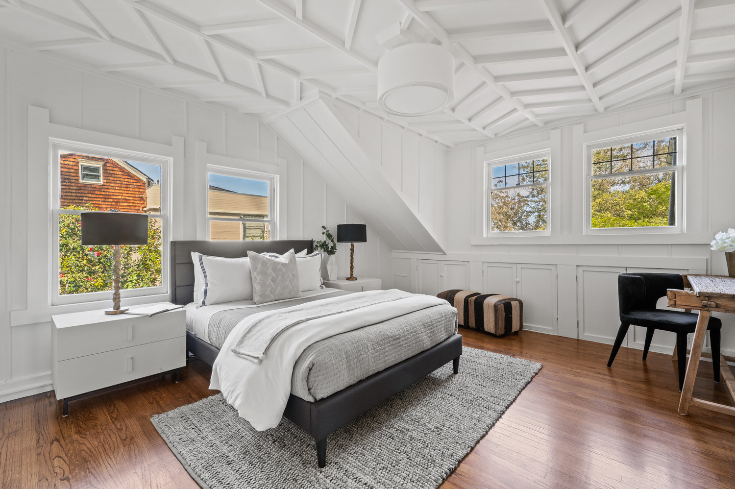 093photos281edgewood070 This guest room has stunning chevron wood detailing on the ceiling. There is a queen bed with two bedside tables.