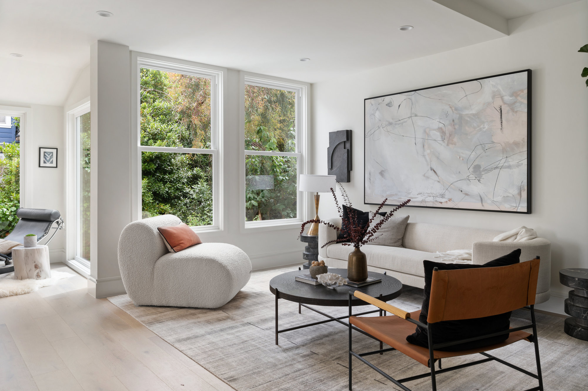 The living room space has couch and two sitting chairs.