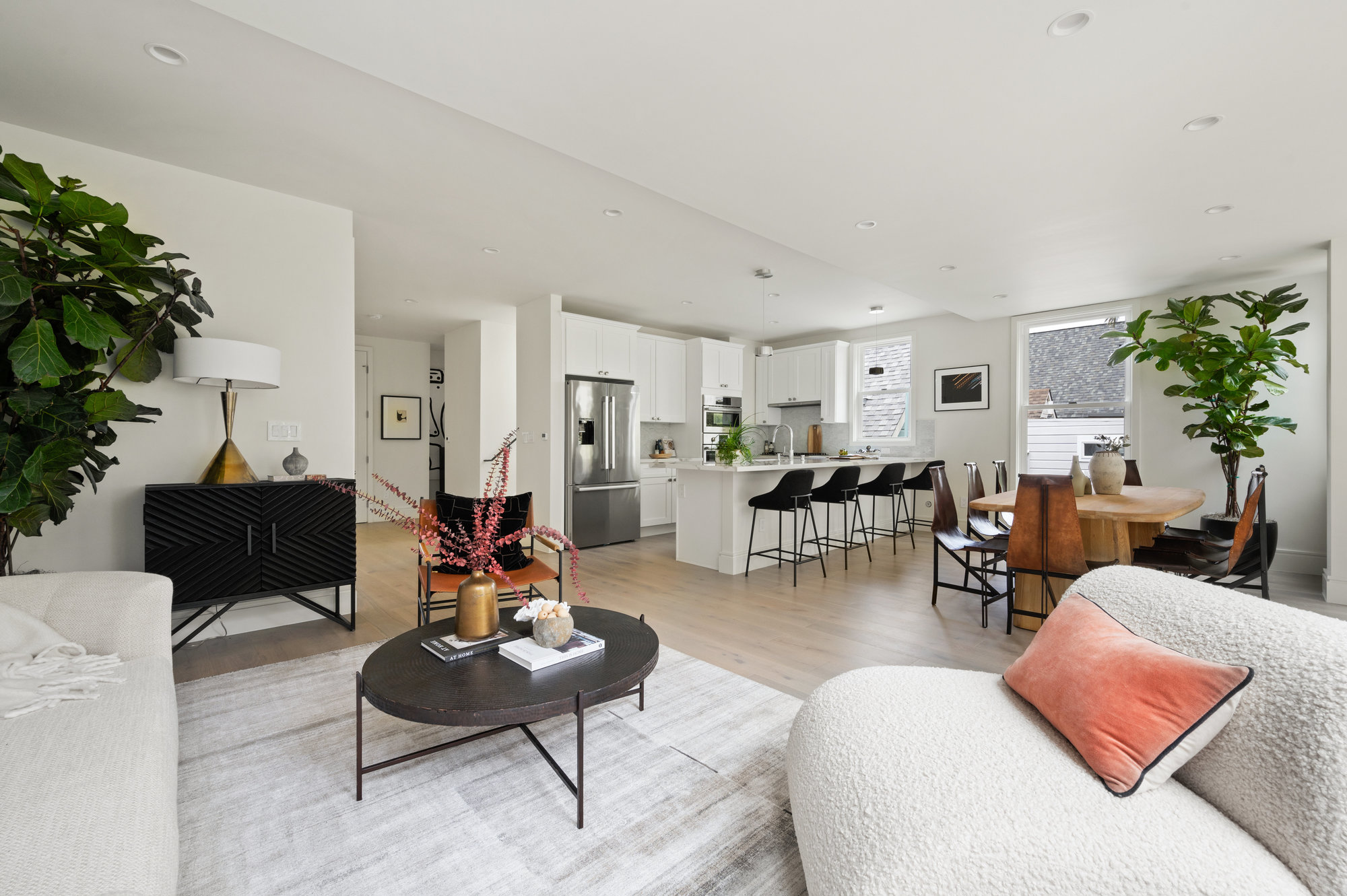 Looking at kitchen from living room.  There is a large island that has four chairs.