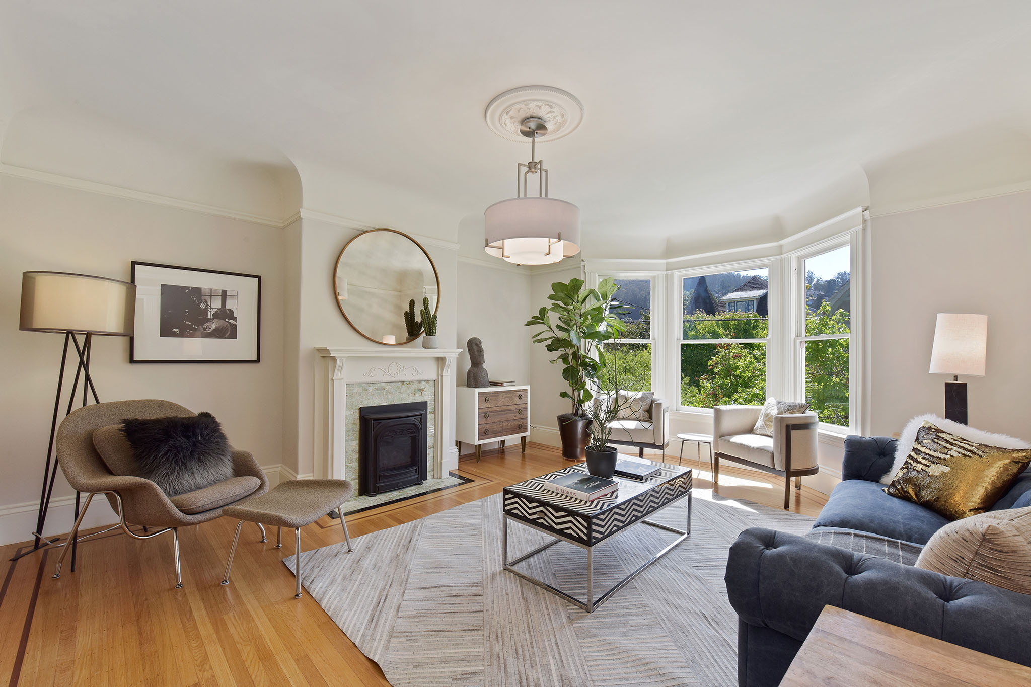 Living room, showing a fireplace with white mantle and bay windows