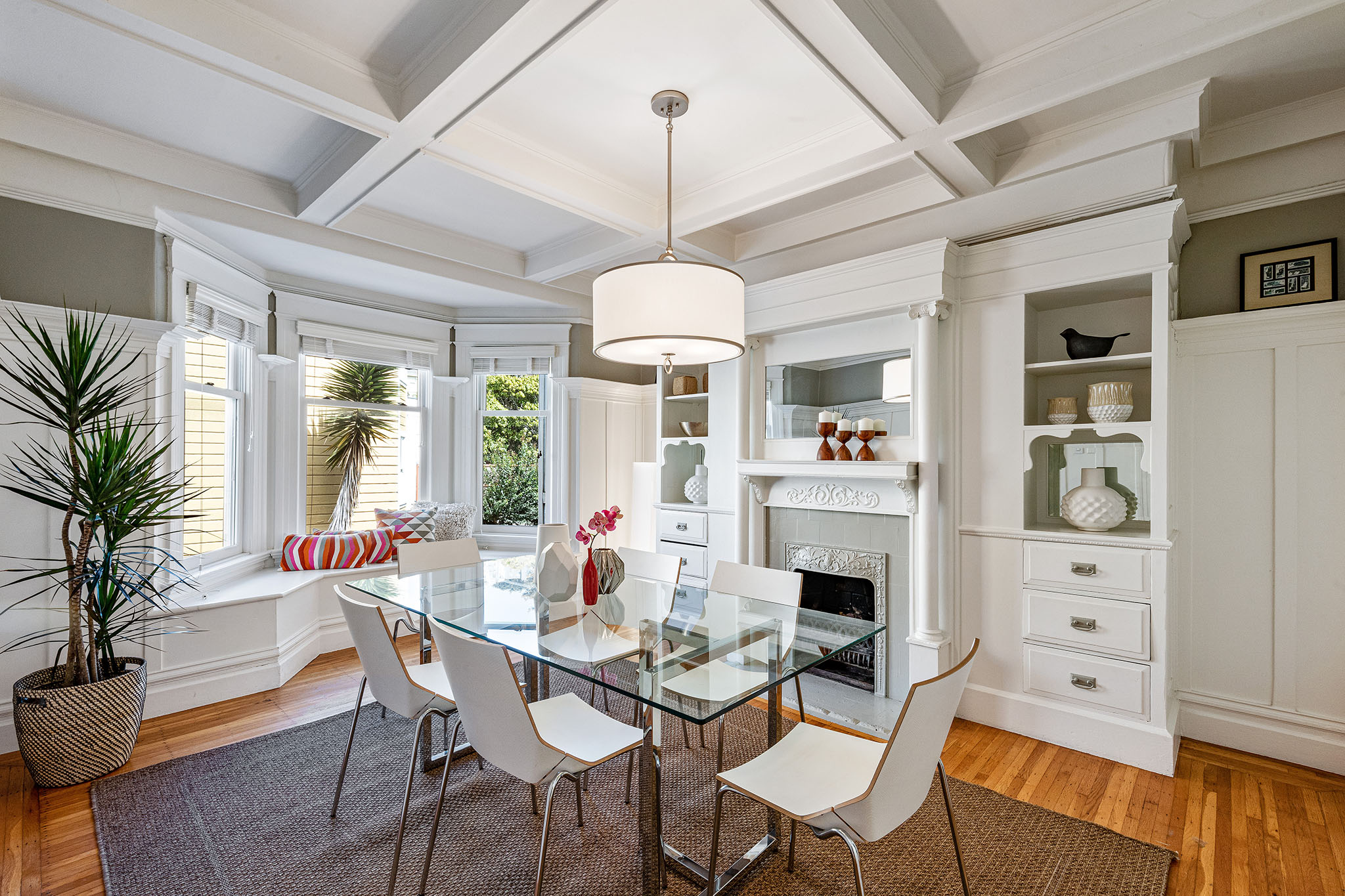 View of the formal dining room, featuring boxed ceilings and wood floors