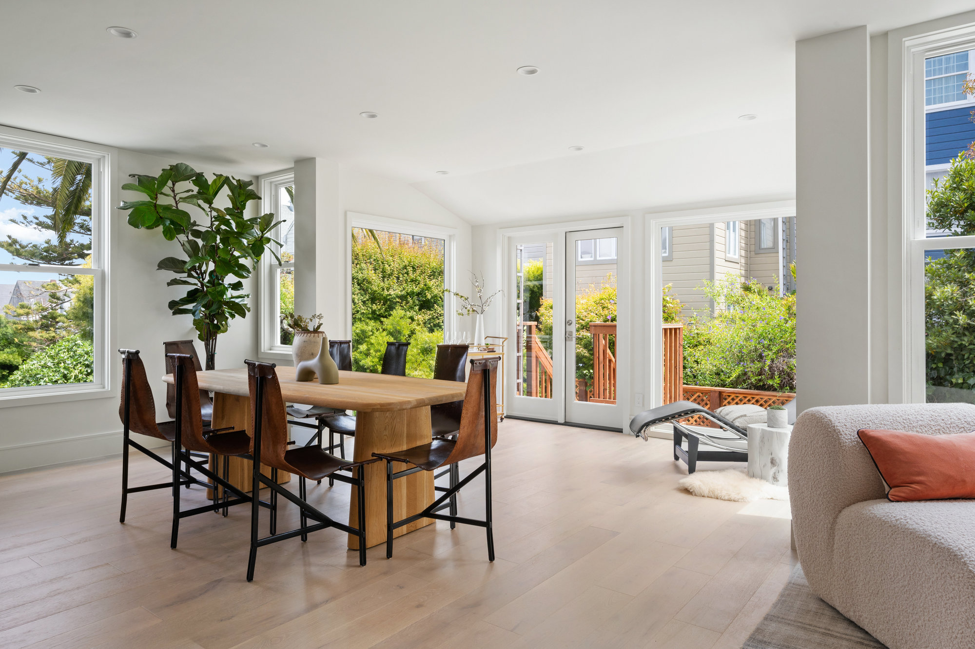 There is a large oval dining table and then there is a sitting area in the backside of room.