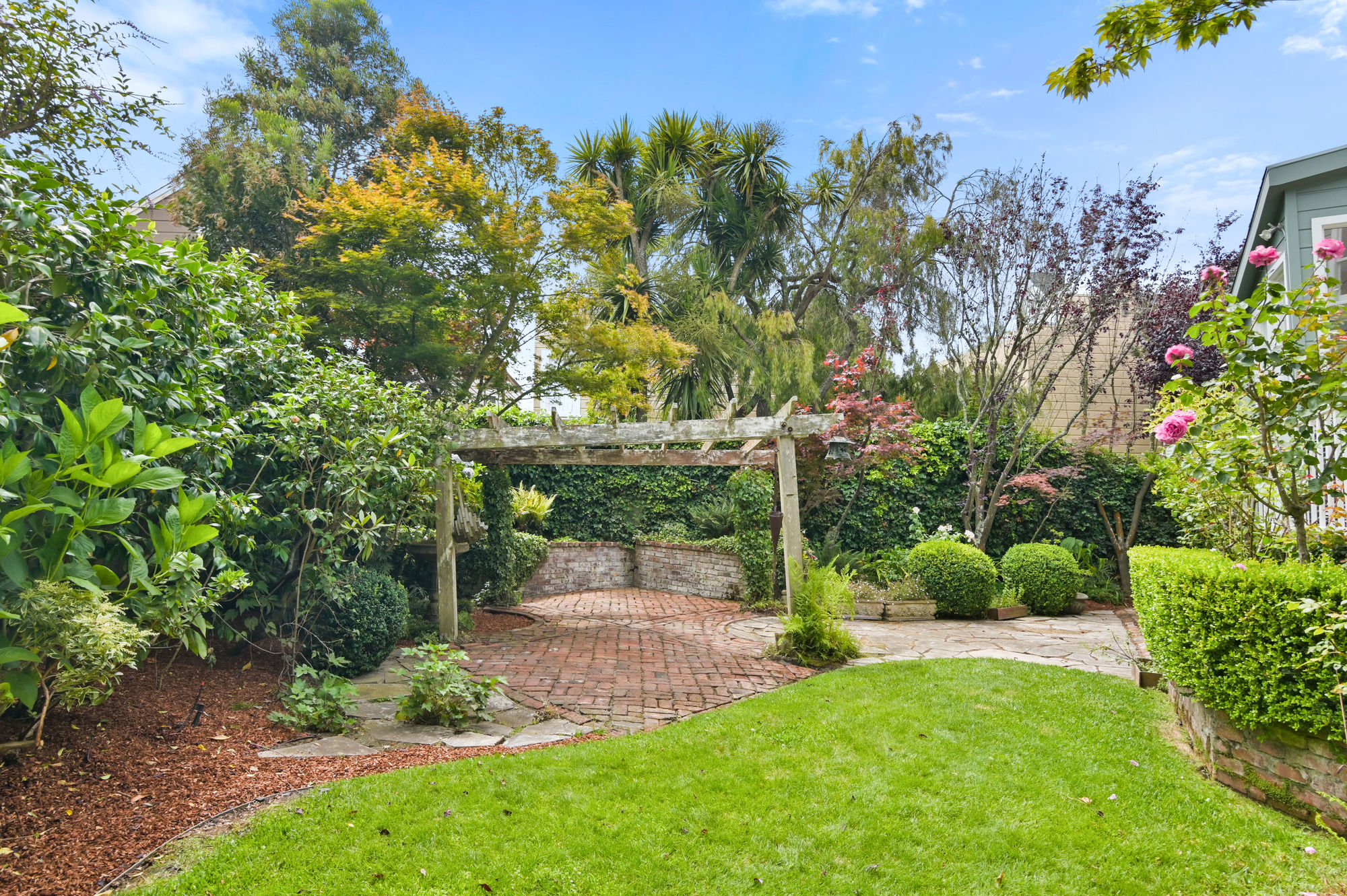 Rear yard with pergola and stone patio