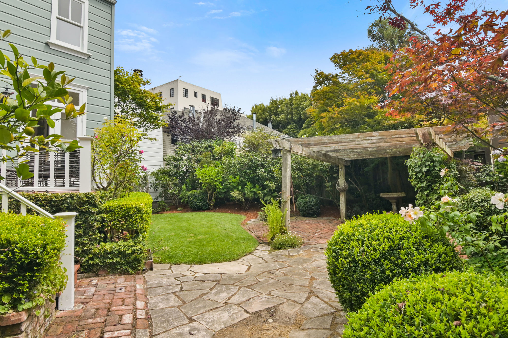 Yard with stone walk-way, pergola and beautiful landscaping