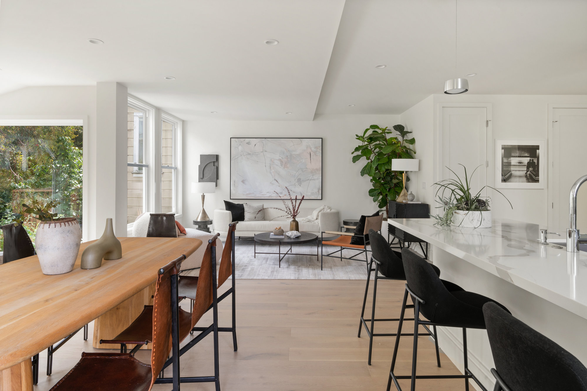 Looking over kitchen and dining space into living room.