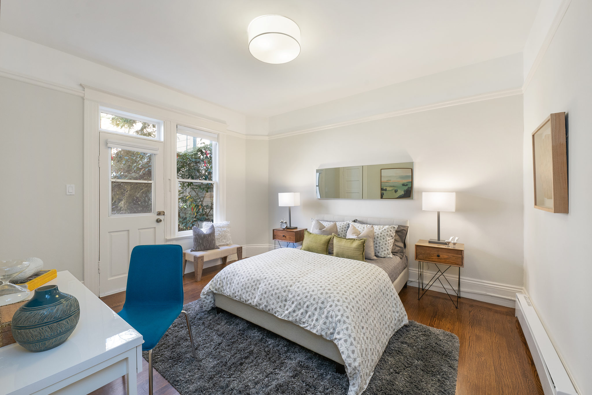View of a bedroom with desk area and an exterior door