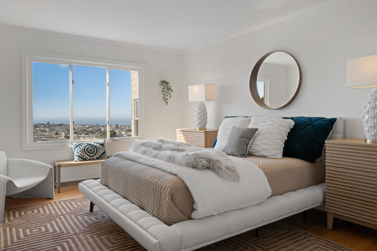 First upper level bedroom has queen bed and large window that lets in lots of natural light.