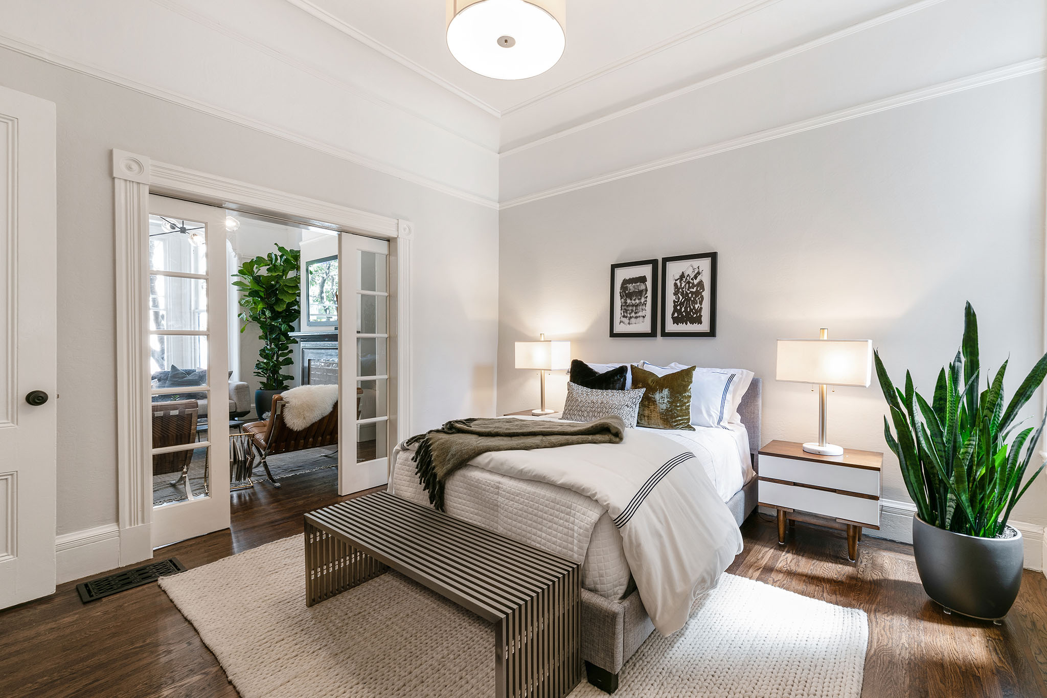 11-1 View of the bedroom, showing glass pocket doors leading to the living room