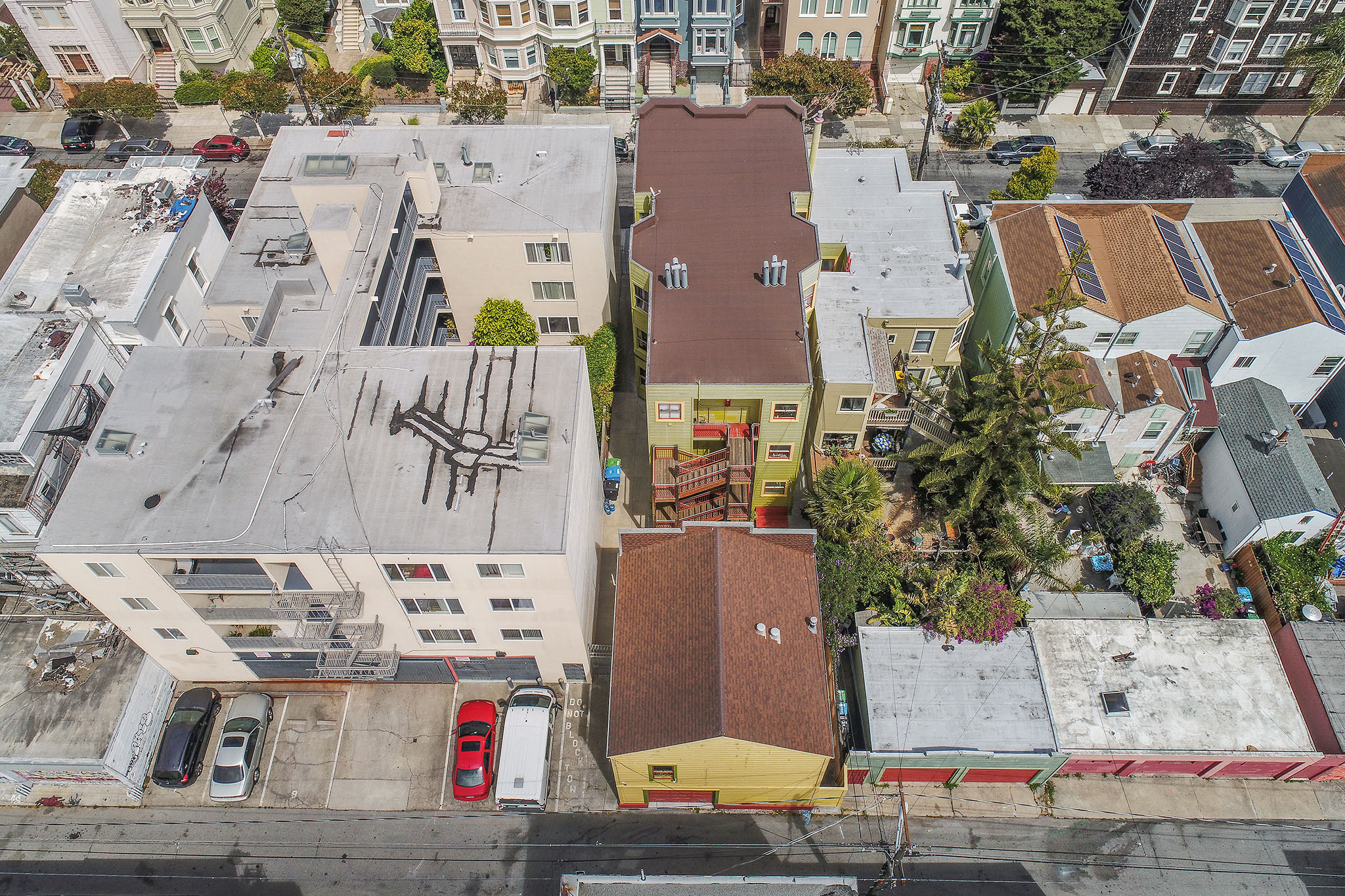 Aerial view of 464-468 Bartlett Street, showing the three story property and a single family residence on one lot