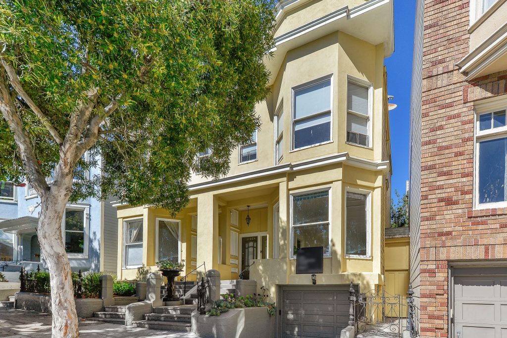 Front exterior of 1102 Fulton Street, featuring a yellow facade