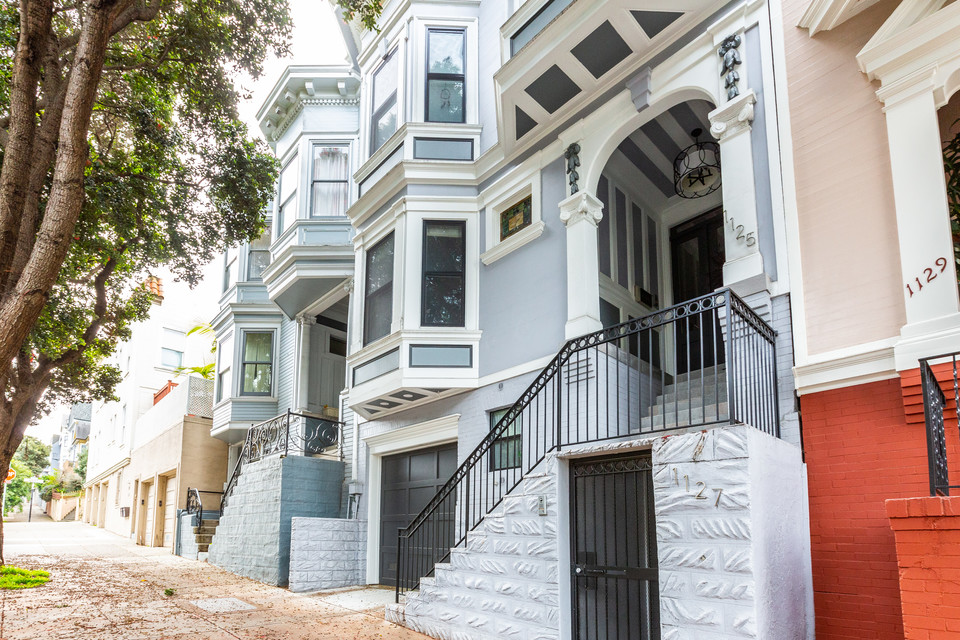 Front exterior view of 1125-27 Broderick, featuring a home with pale blue facade