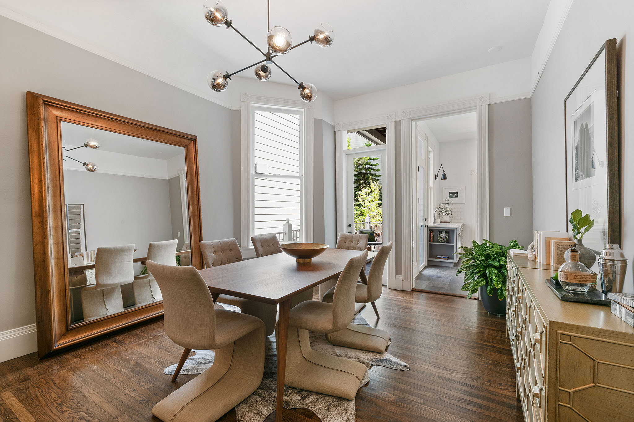 12 View of the large formal dining room, featuring two windows and wood floors